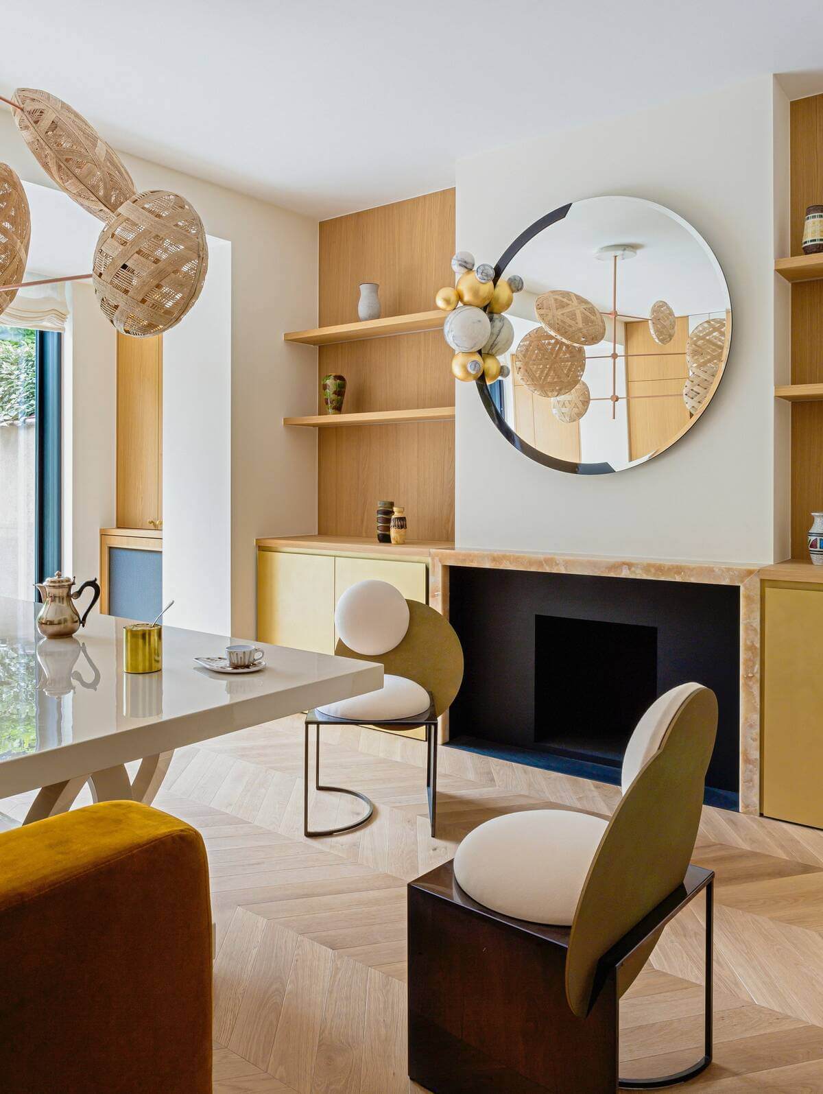 Modern luxury dining chair with a circular backrest, velvet upholstery, and sleek metal legs, styled in a contemporary summer house interior with natural light, wood accents, and designer decor.

