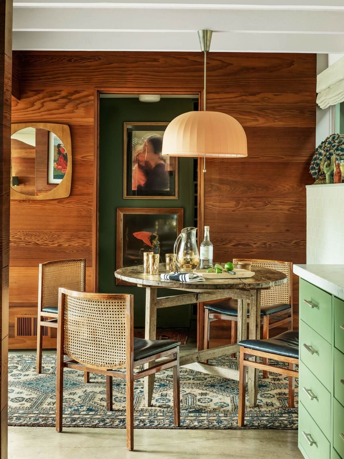 A round dining table and set of vintage chairs at Dakota Johnson’s kitchen