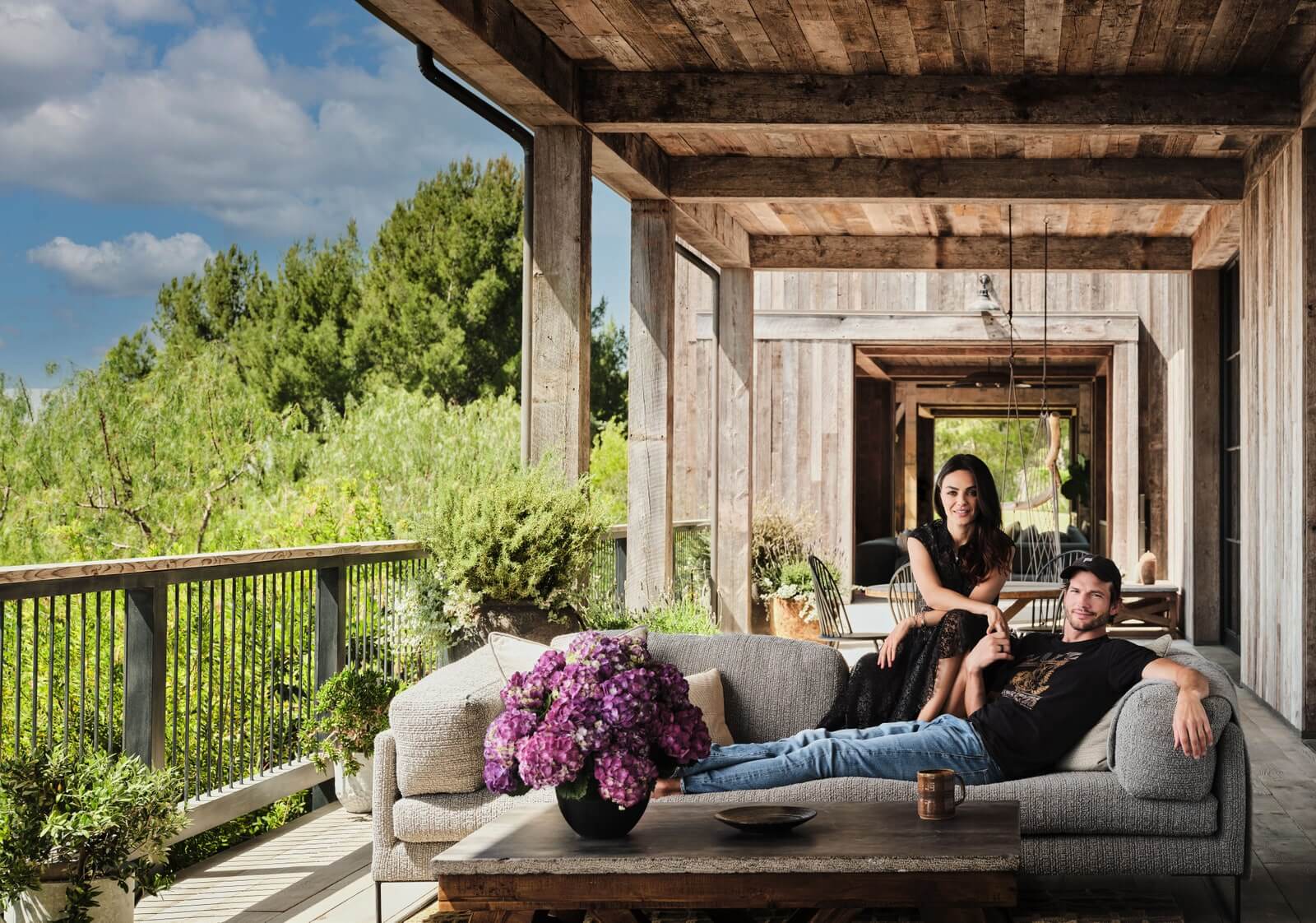 mila kunis and ashton kutcher on the outdoor are of their farm house