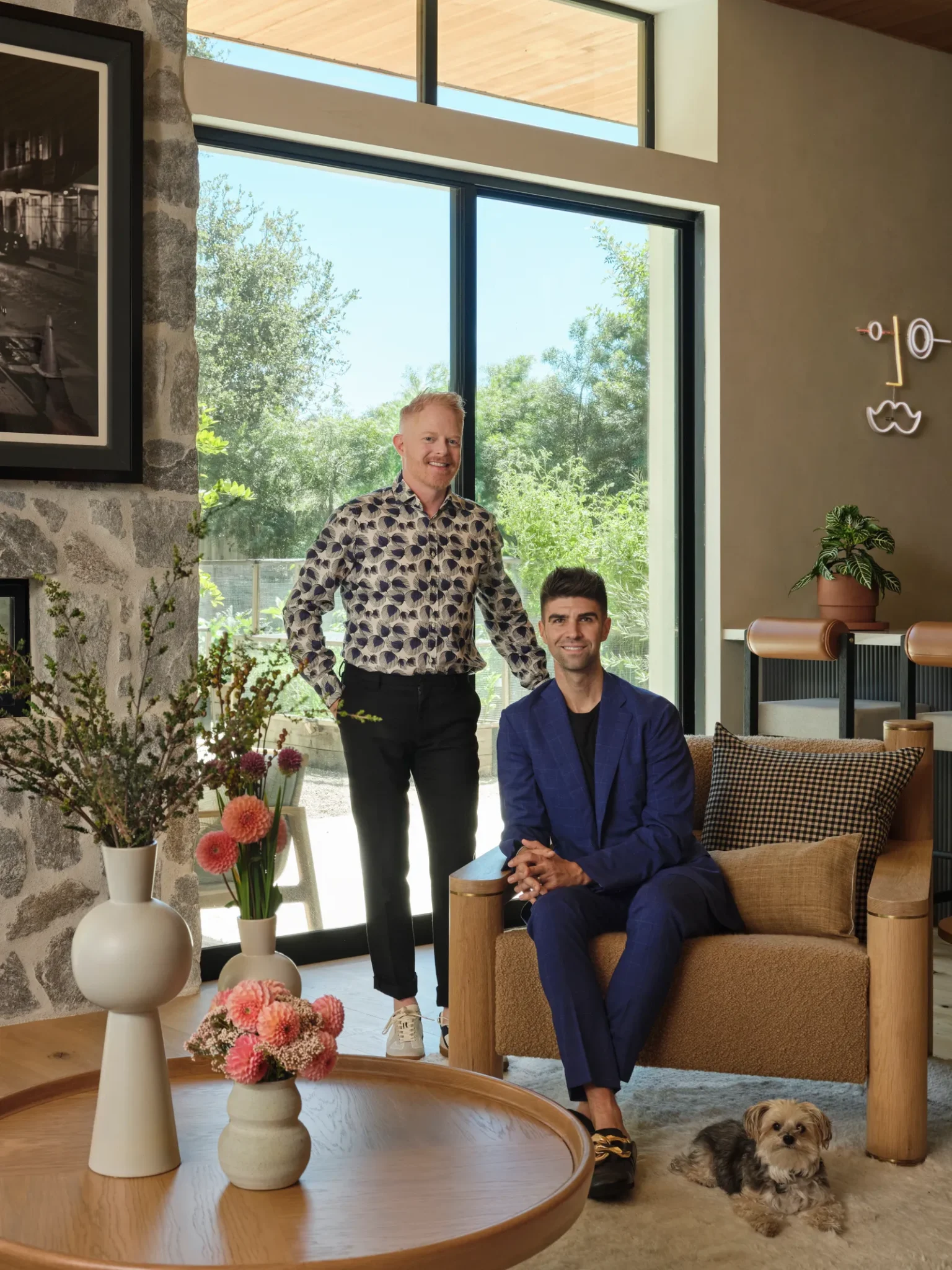 Jesse Tyler, his husband and theirs dog in the living room 