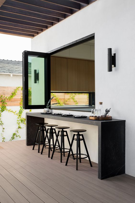 Outdoor bar with a window to the indoor kitchen