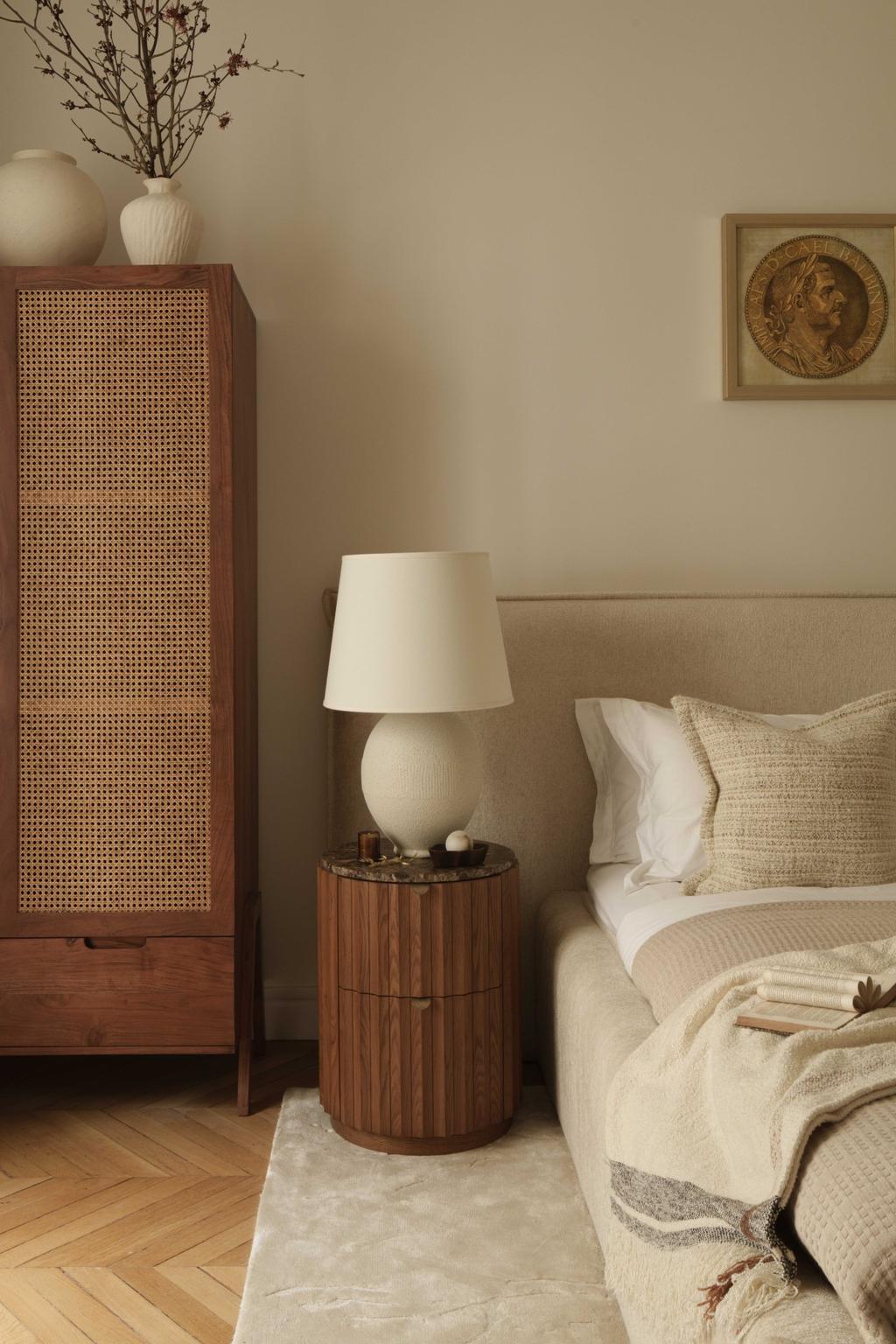 bedroom with bedside table with a table lamp and a bedroom with. neutral tones