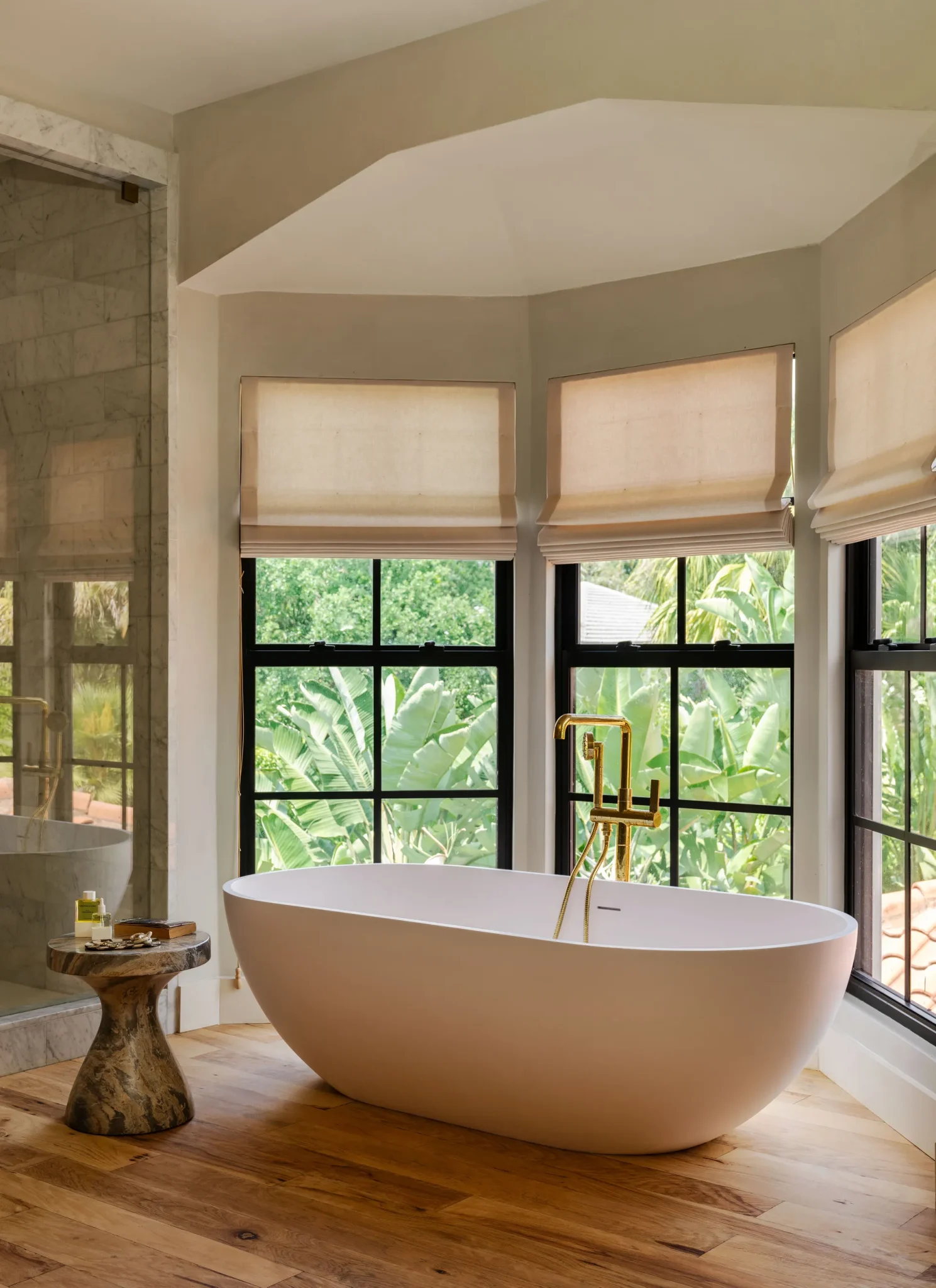 Bathroom featuring a freestanding bathtub and a stone sidetable for support