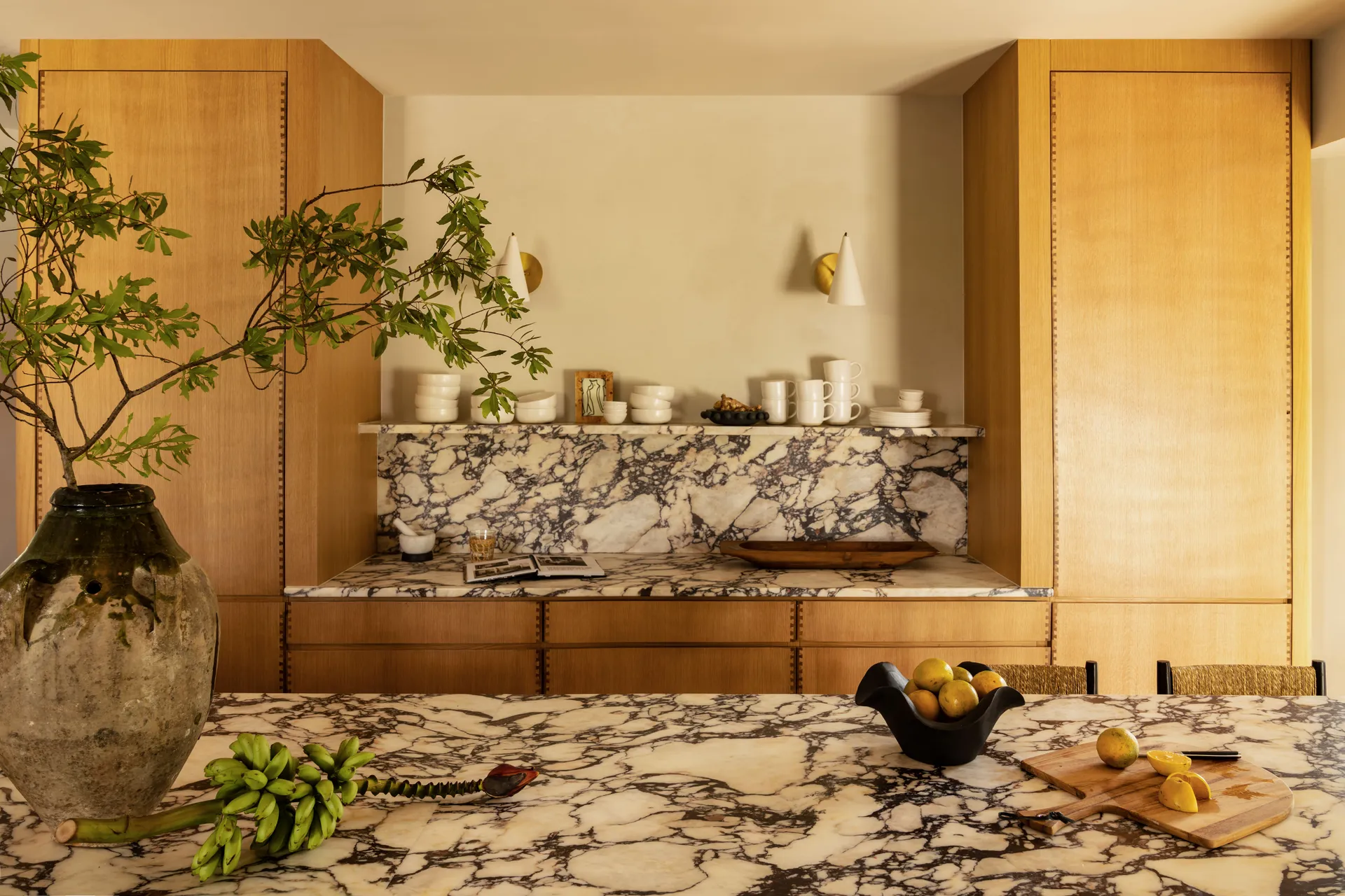 The marble countertops of the kitchen island and the kitchen counter