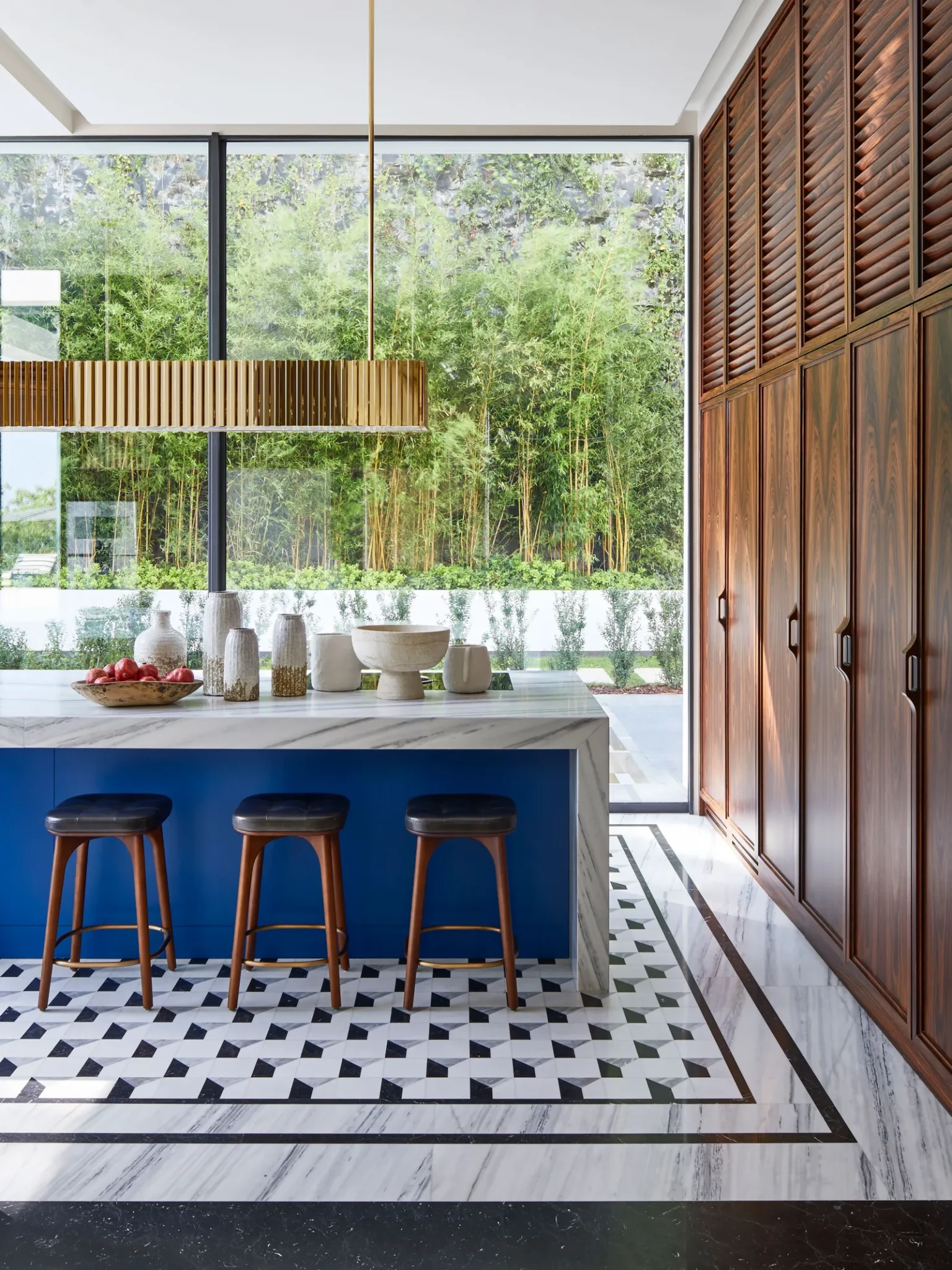 Kitchen featuring an exquisite patterned flooring and a marble kitchen island with blue wood on the sides
