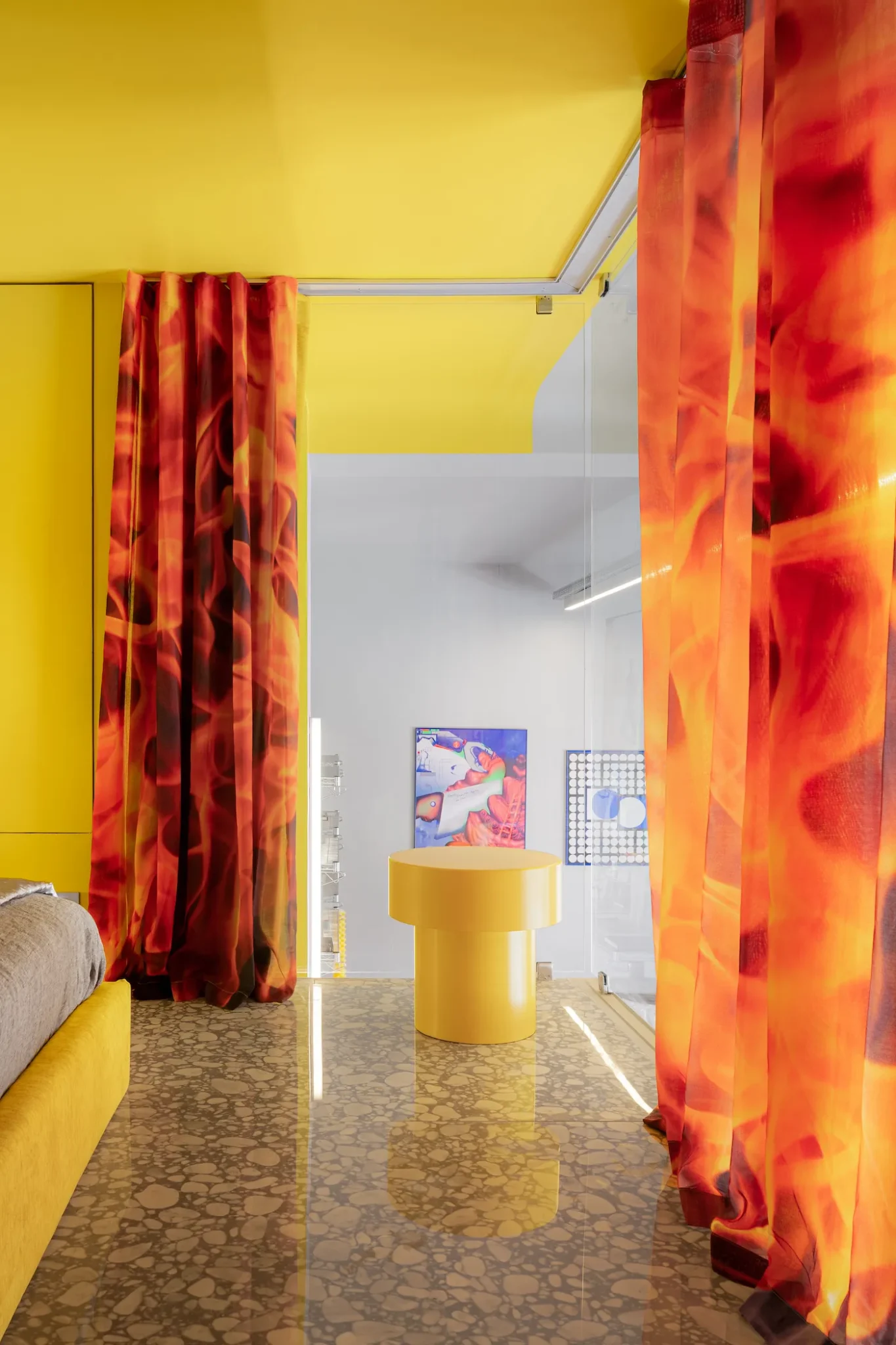 bedroom with yellow stools and flaming curtains 