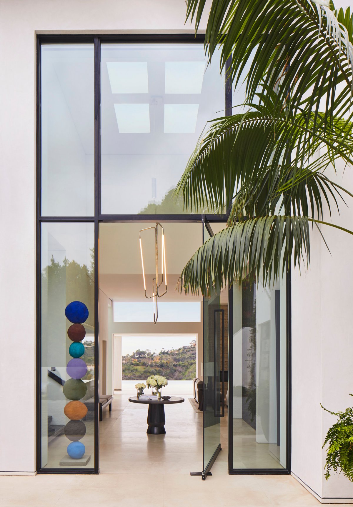Large glass door with panoramic view. Entryway inspired by nature.