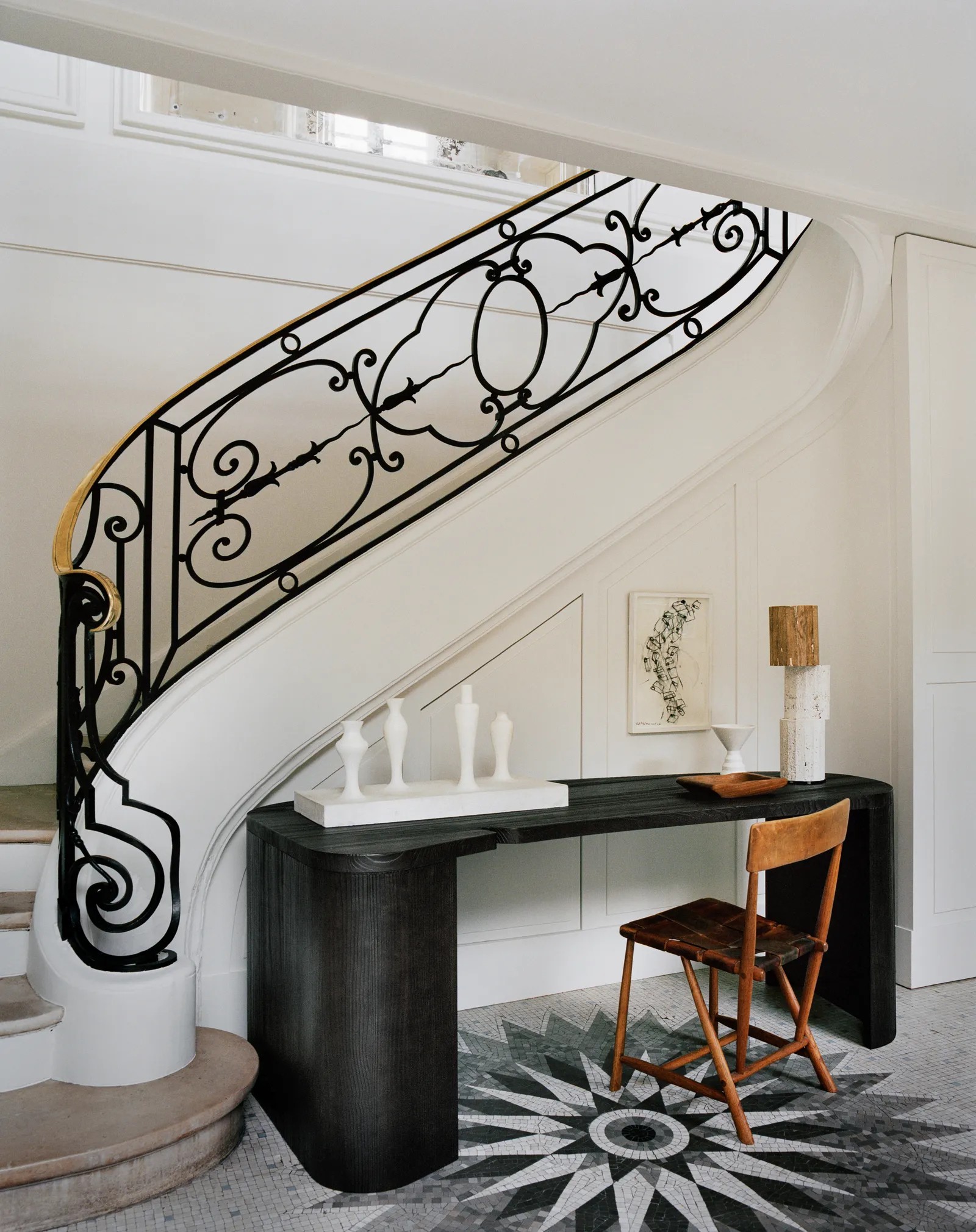 Entry with a big curved staircase with a crafted railing