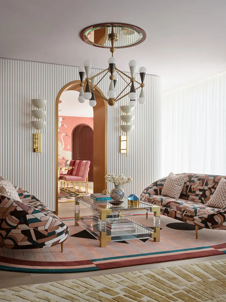 art deco interior design - pink living room with bold sofa and gold details 