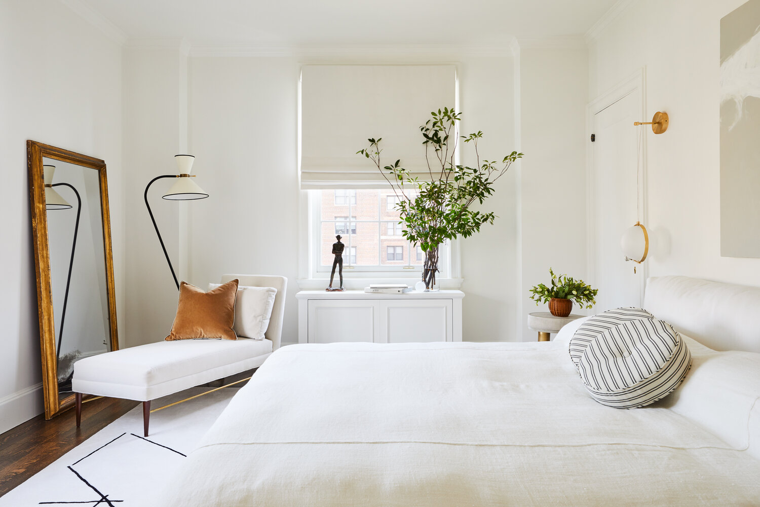 a minimalist bedroom with white details.