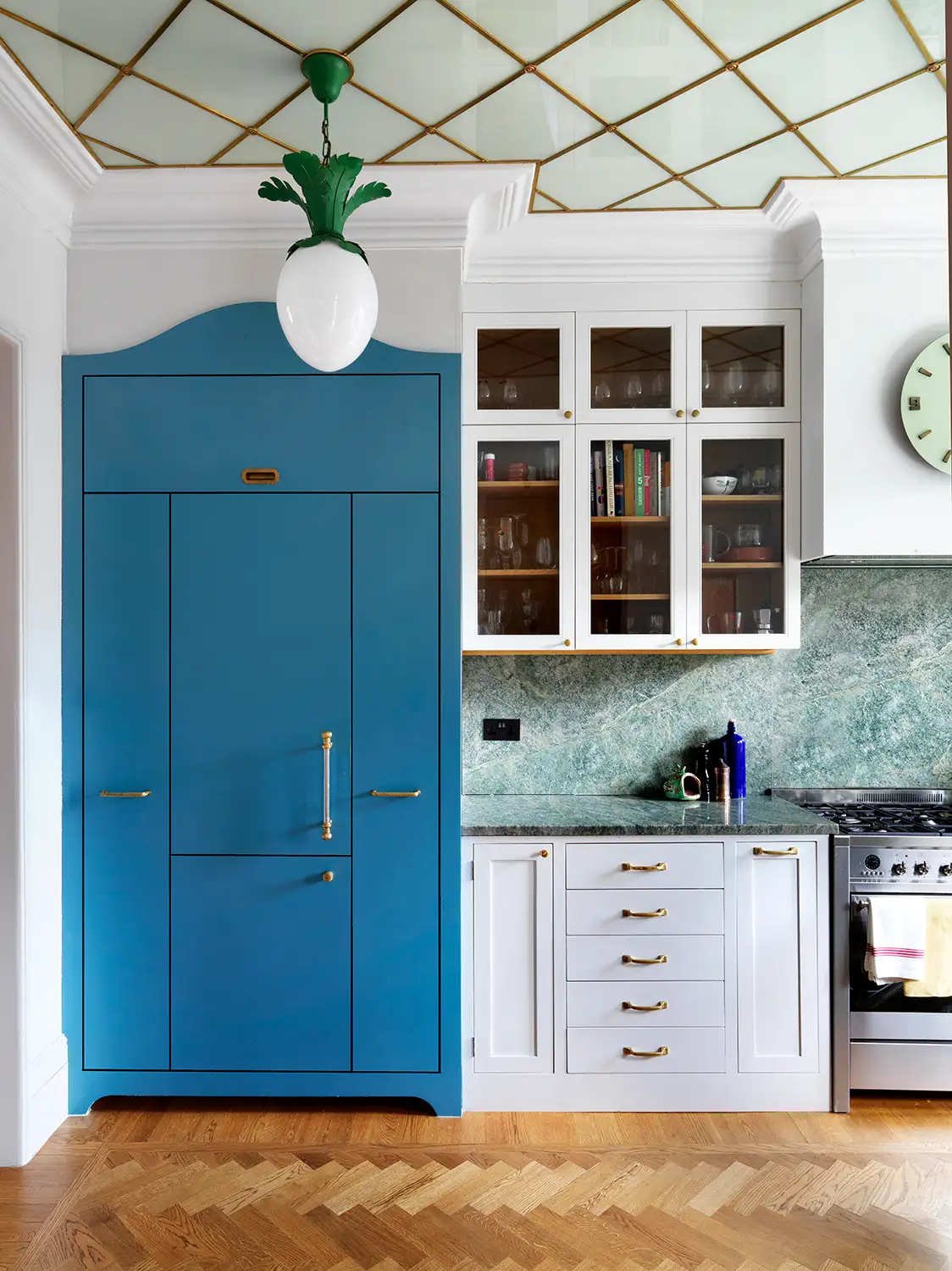 A kitchen with a big blue cabinet and and an amazing glass ceiling
