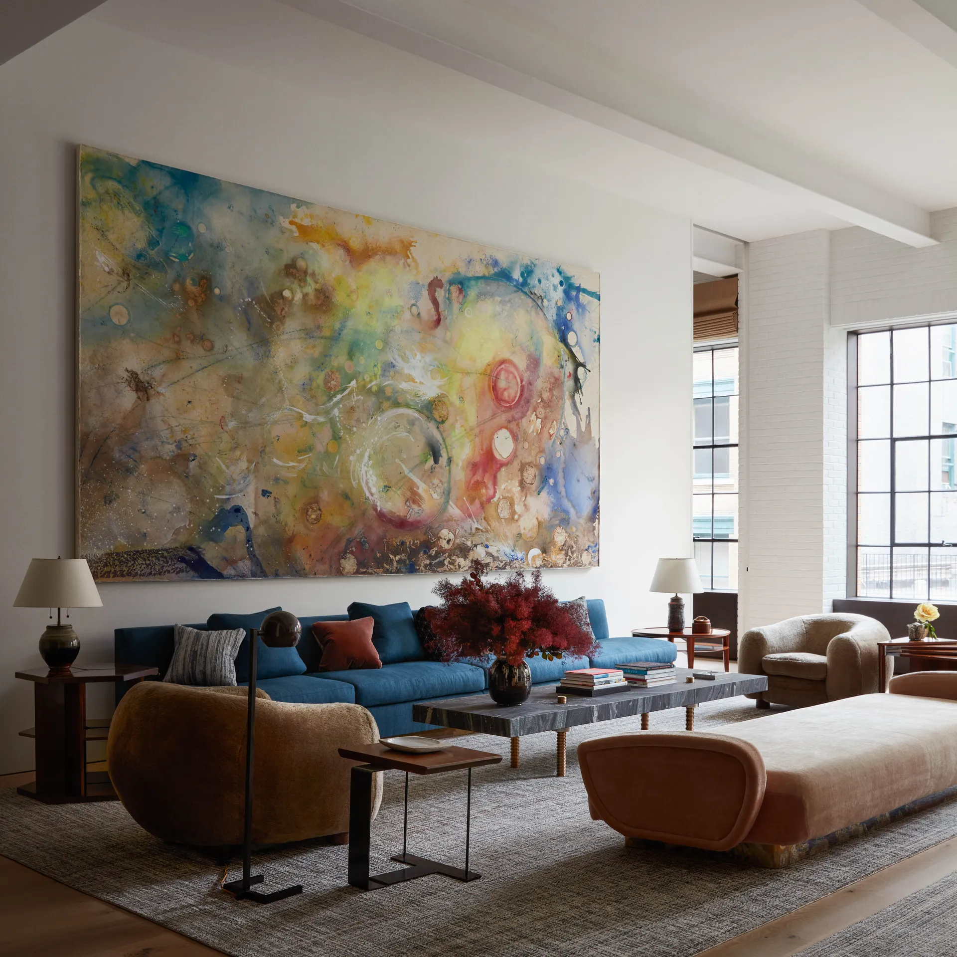 A modern living room with a large art frame in the wall