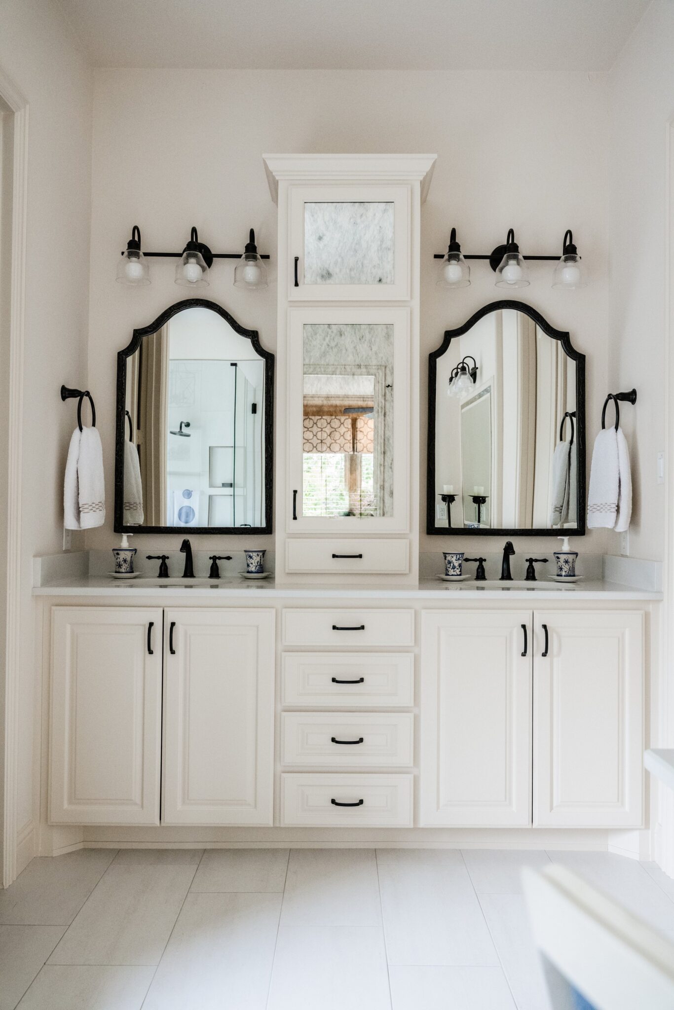 White chic bathroom with black detailed mirrors