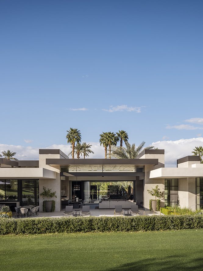 a contemporary house in California with palm trees in the background.
