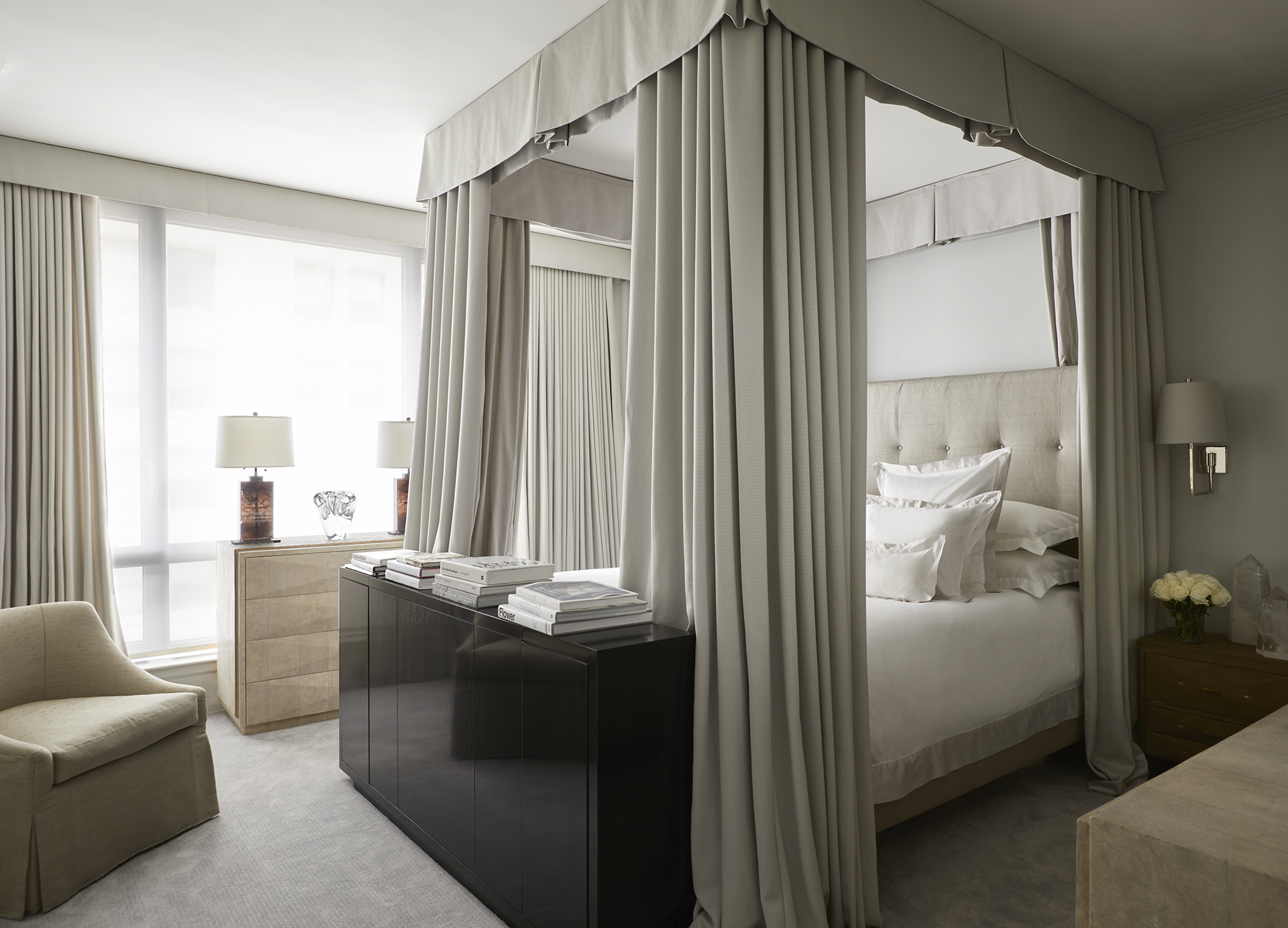 Modern bedroom featuring a canopy bed 