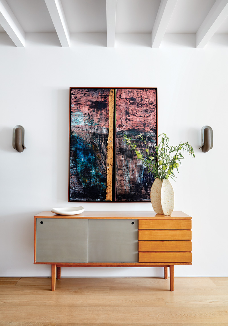 A Sterling Ruby artwork on top of a vintage credenza in the living room