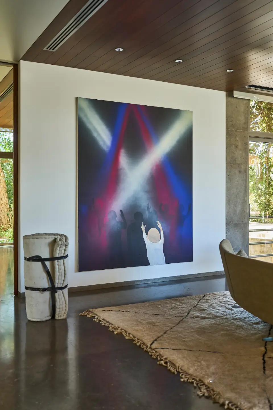 Large canvas artwork on the wall, a unique handmade rug, a distinctive piece of art, and handcrafted furniture in the living room