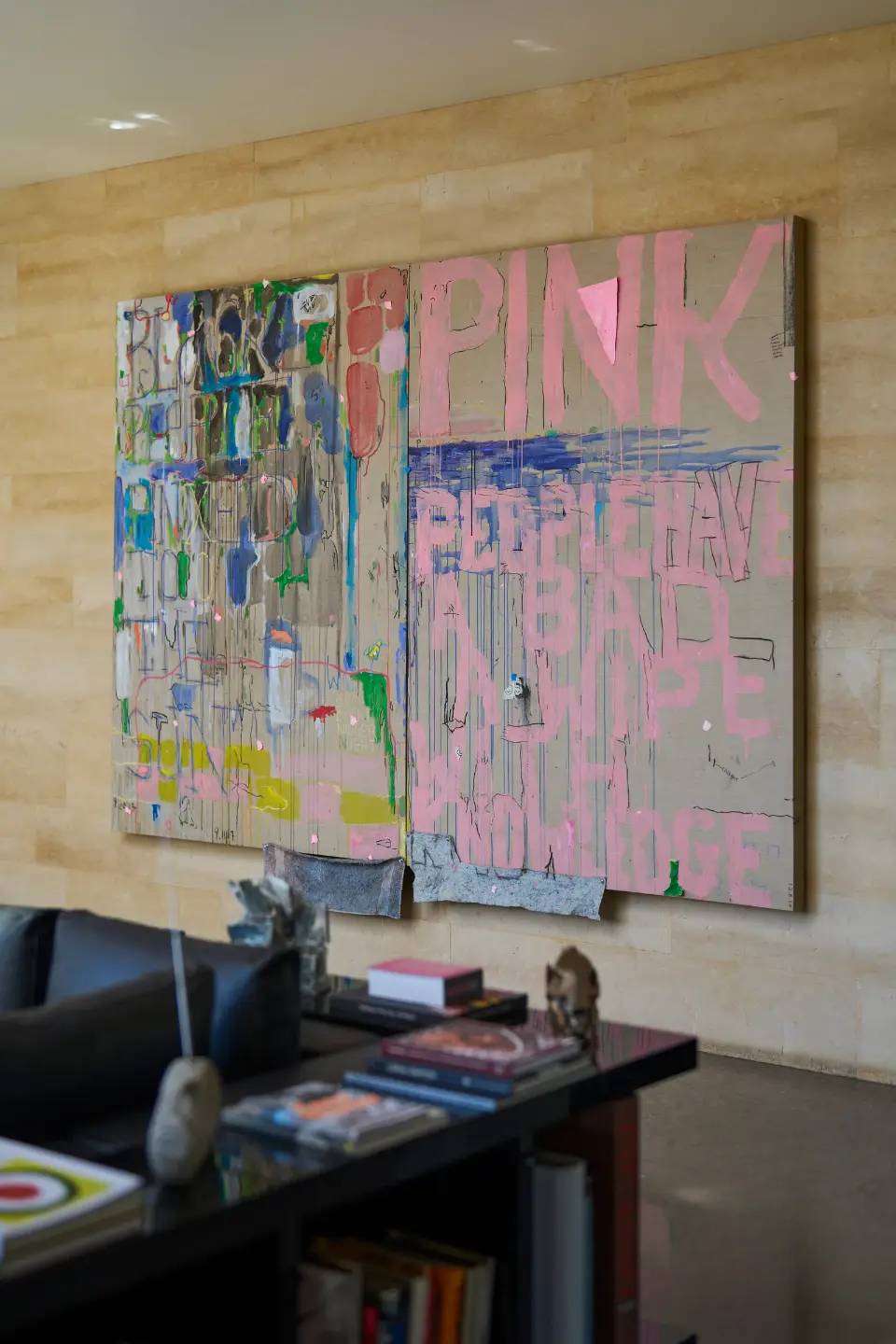 Original canvas by a renowned artist on the wall, with a square coffee table beside a leather sofa in the living room