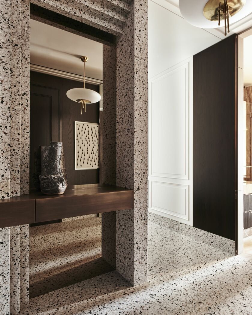 an entry in natural stone polished floors and walls