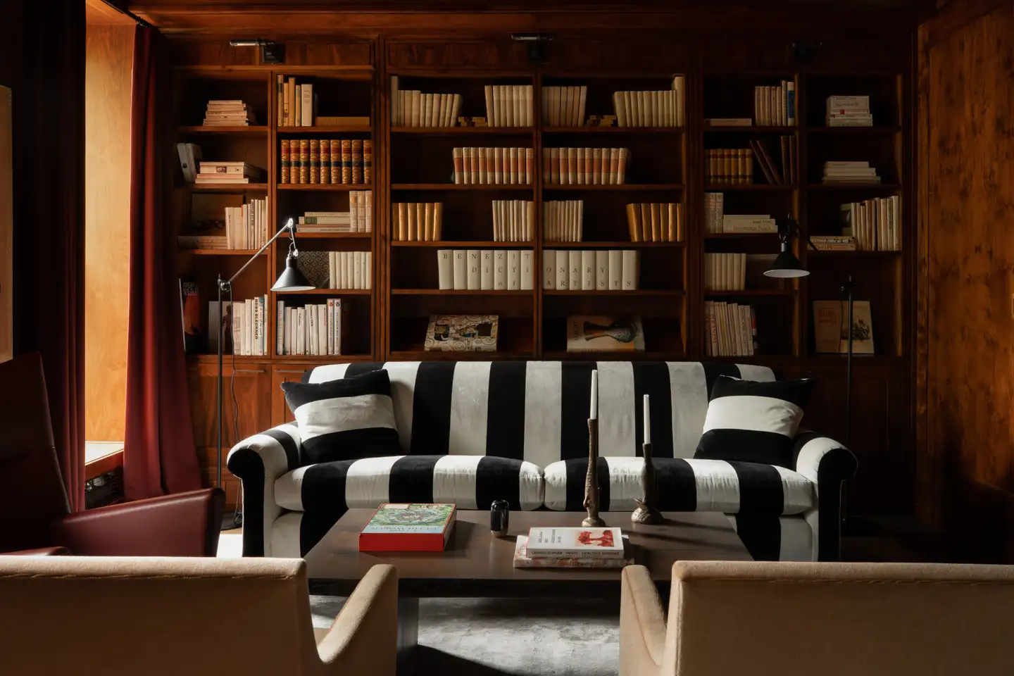 English-style black and white striped sofa that contrasts with the rest of the study