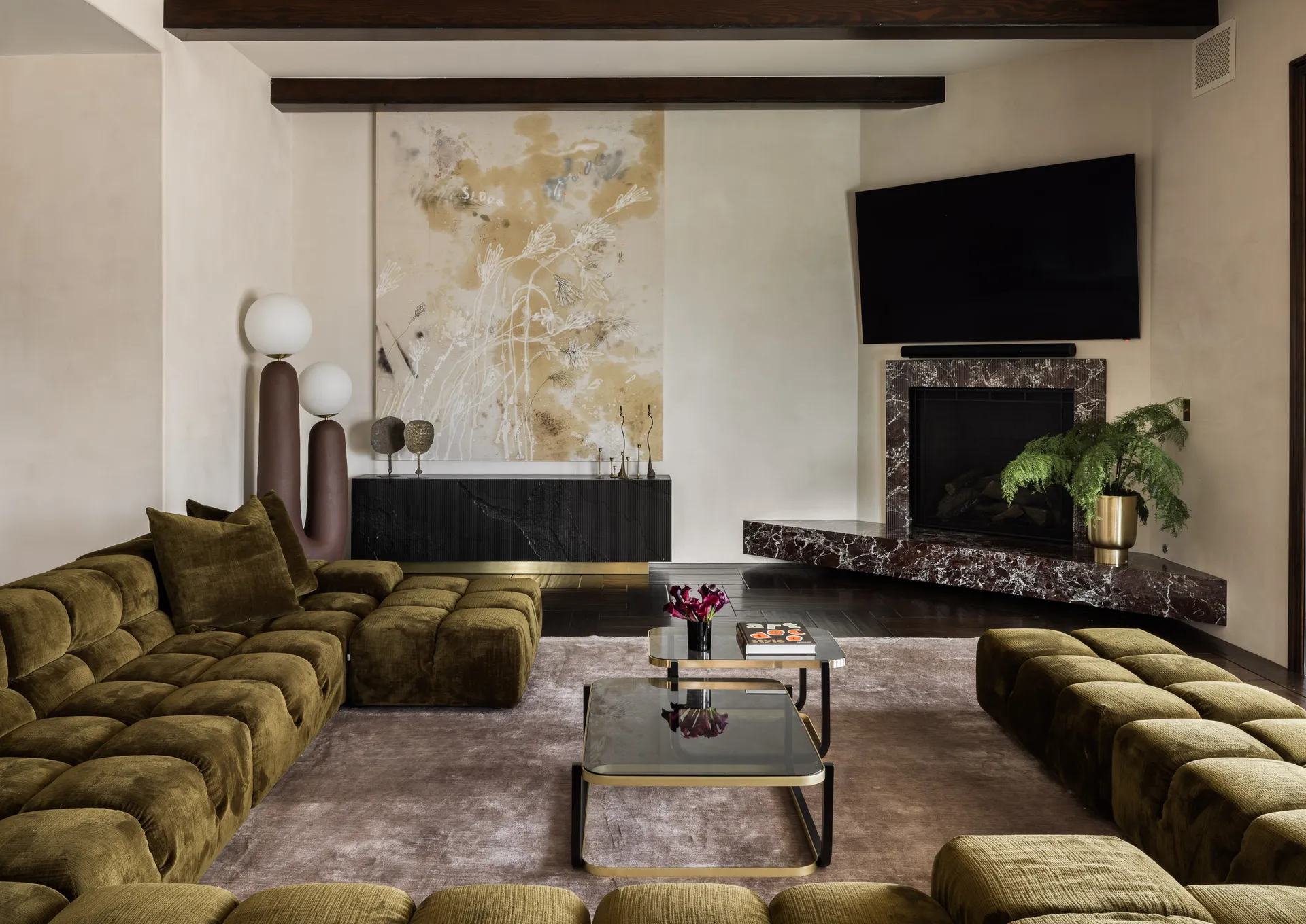 family room with green sofa and neutral tones by huma sulaiman