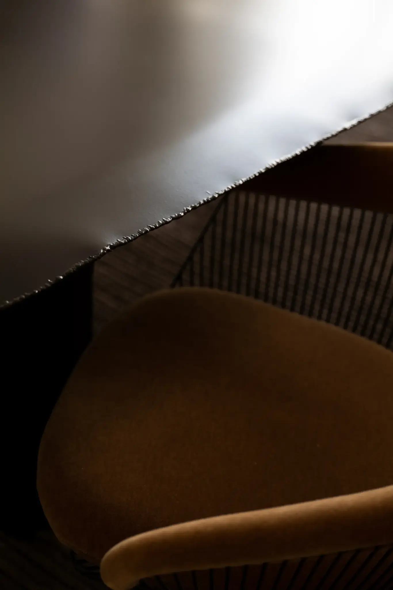 Crafted chair made from natural materials, combining metal and wood for a refined, artisanal look.