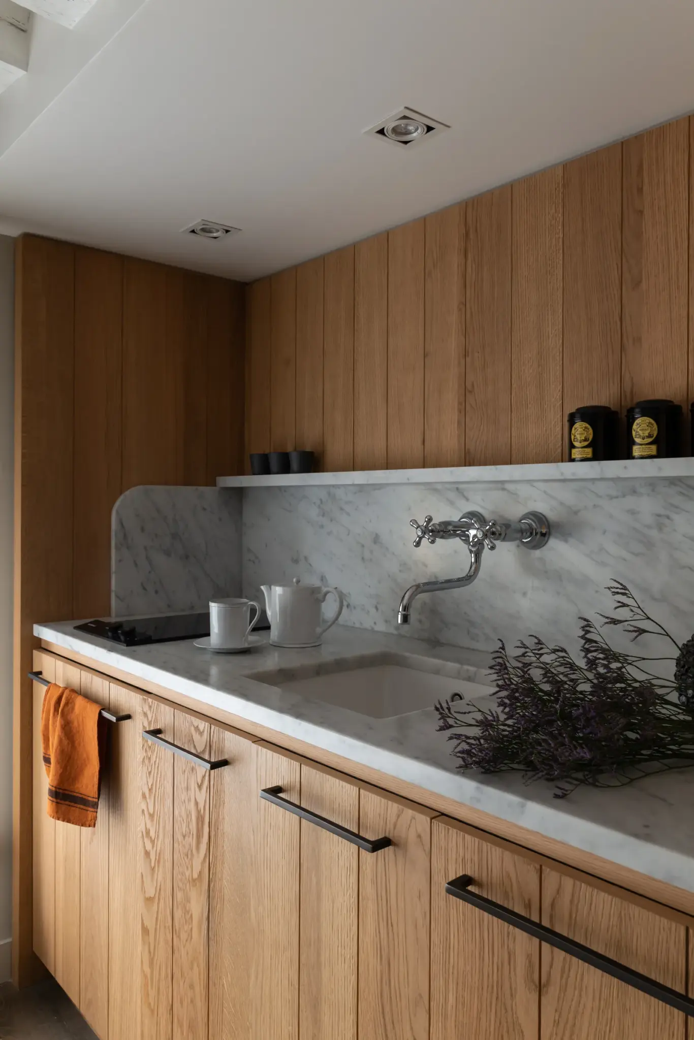 Kitchenette featuring a lavender plant and a natural stone countertop, adding a touch of greenery and organic elegance.