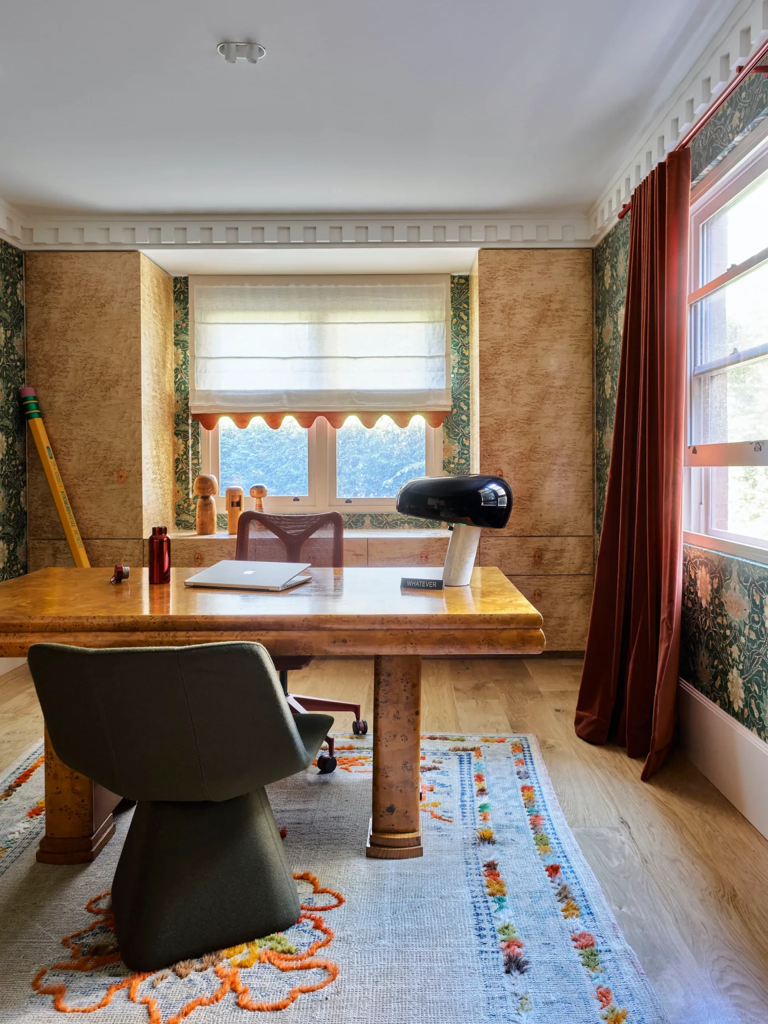 Office featuring a big vintage wooden desk and a memphis table lamp