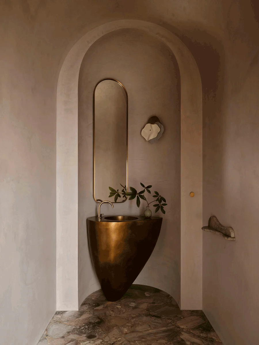 bathroom with unique sink, natural colors, metal sink style