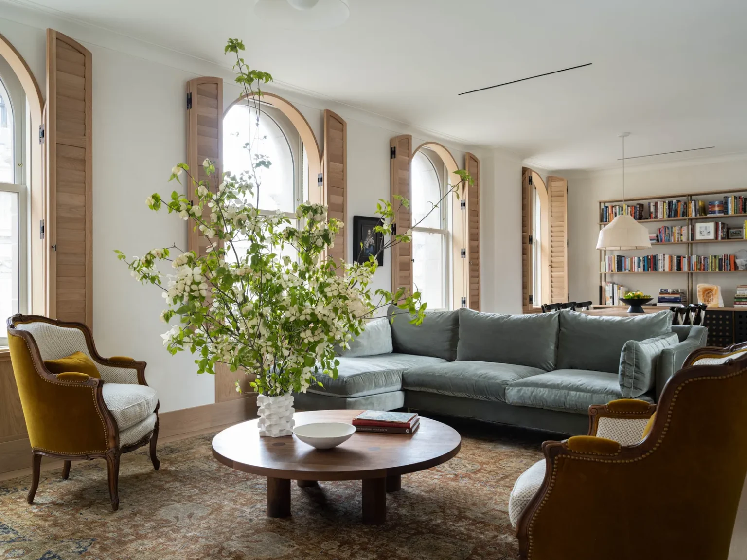 Amana Seyfried living room with a wood coffee table and vintage chairs