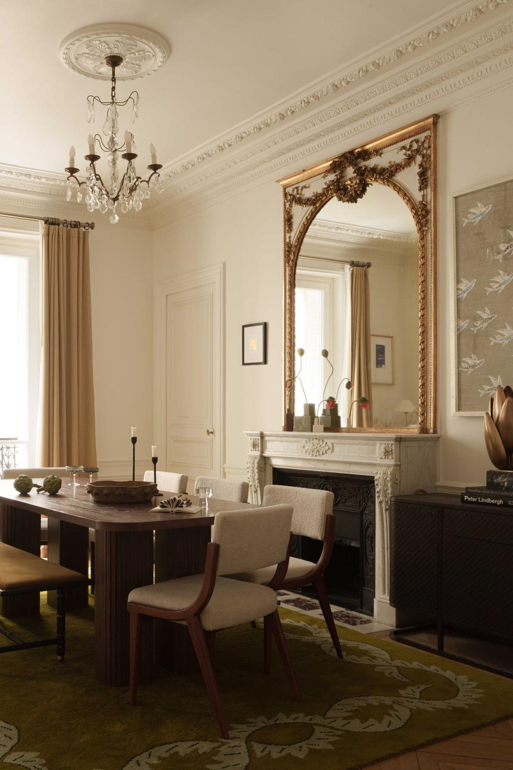 dining room with brown chairs, brown table, a fireplace and a miorror