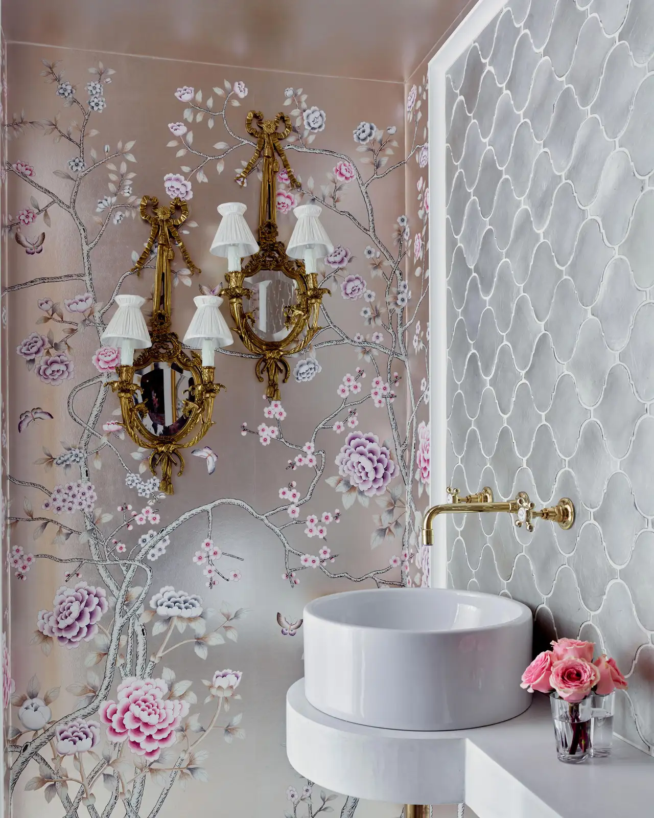 A bathroom with a wallpaper of painted pink flowers