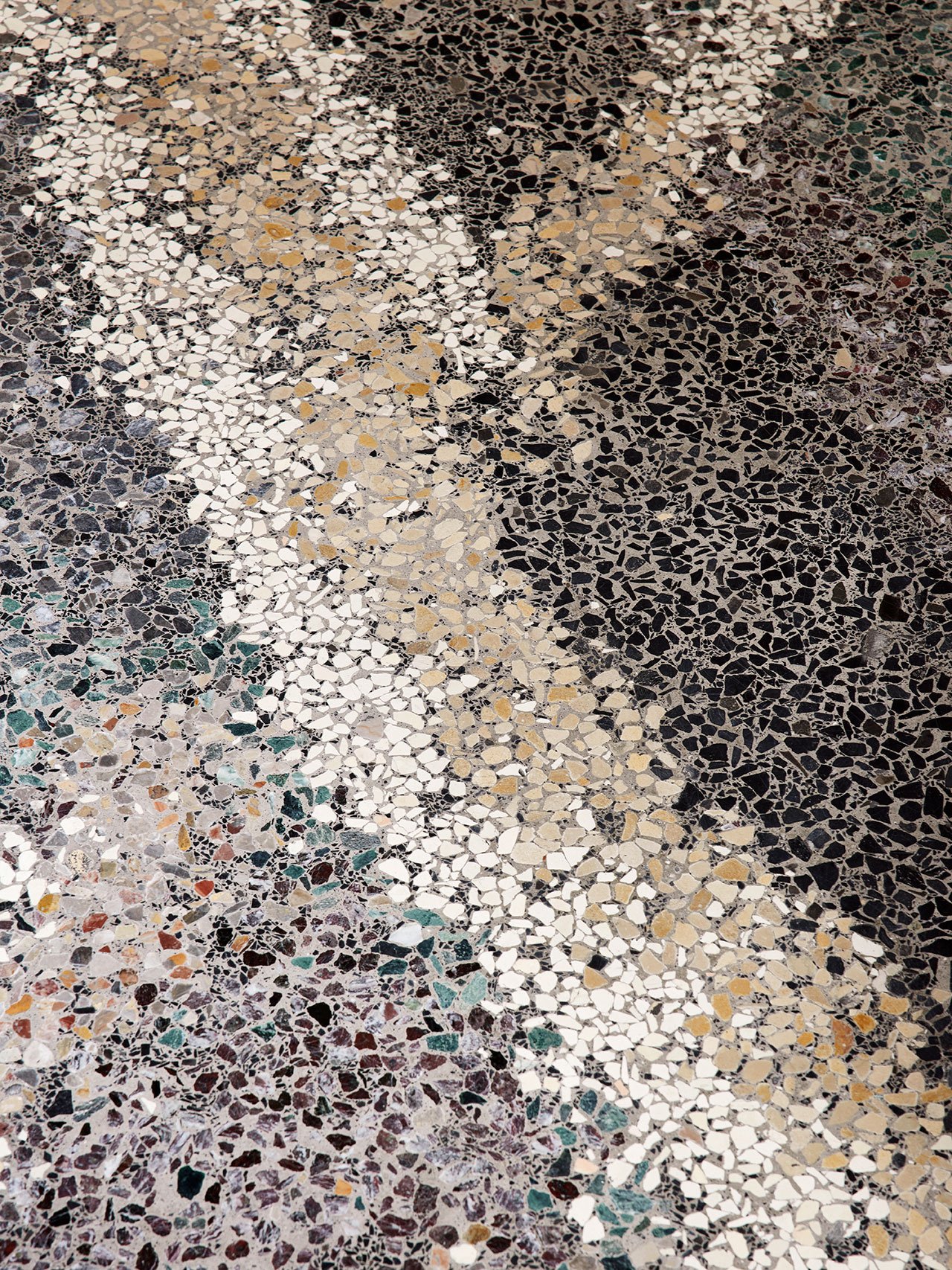 terrazzo flooring with stylized wave pattern