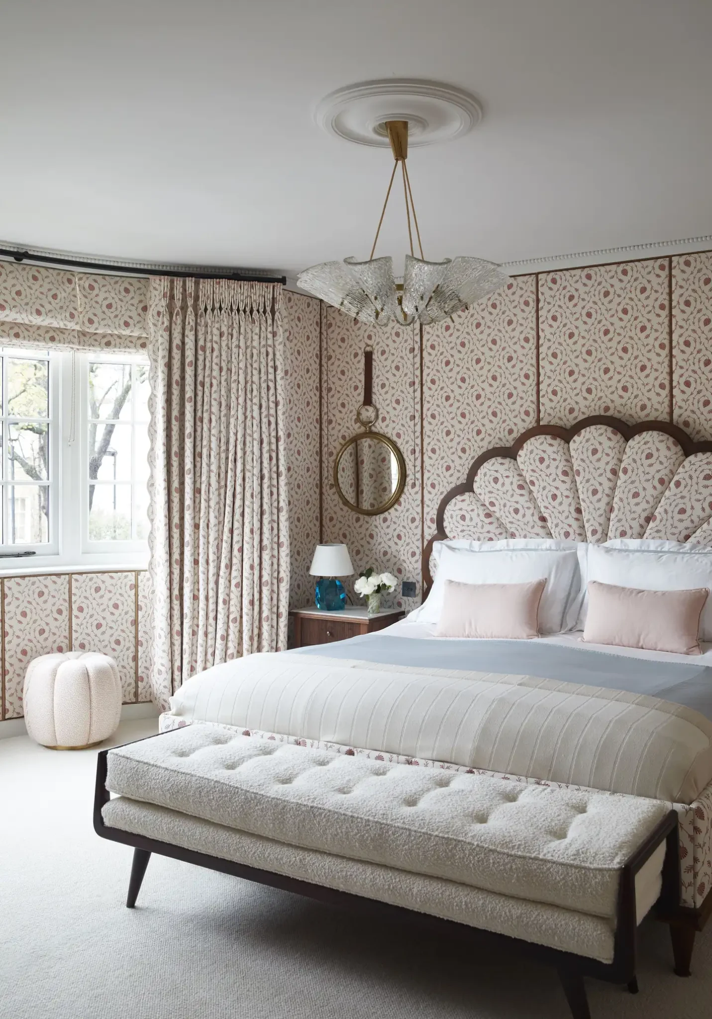 Bedroom with the same pattern on the bed's headboard, wallpaper and curtains
