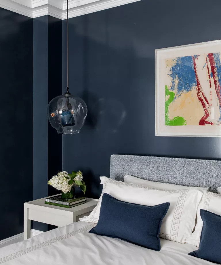 midnight blue bedroom with art painting