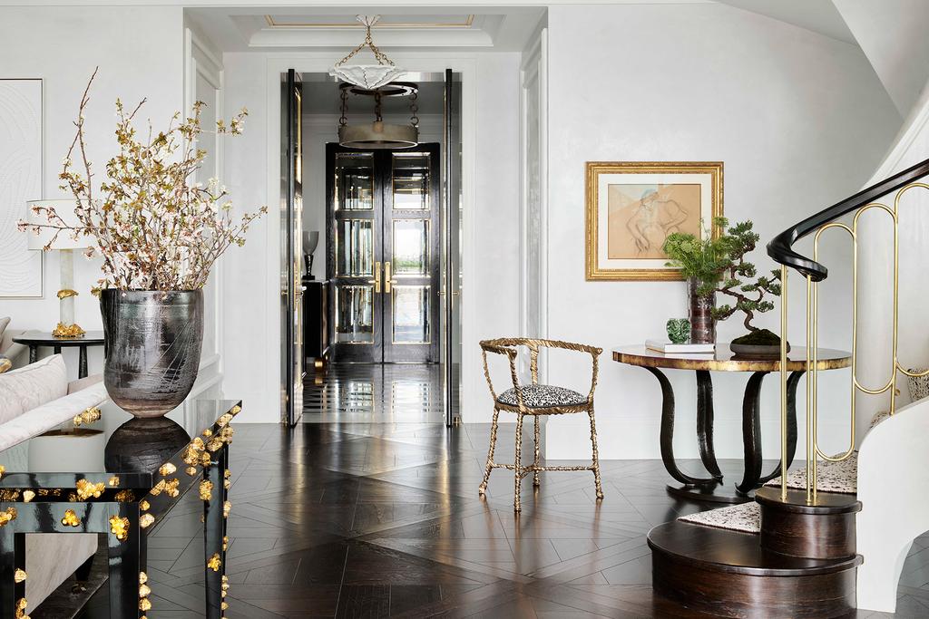 entry to the living room filled with plush seating and beautiful decor that boasts a neutral color palette with accents of gold
