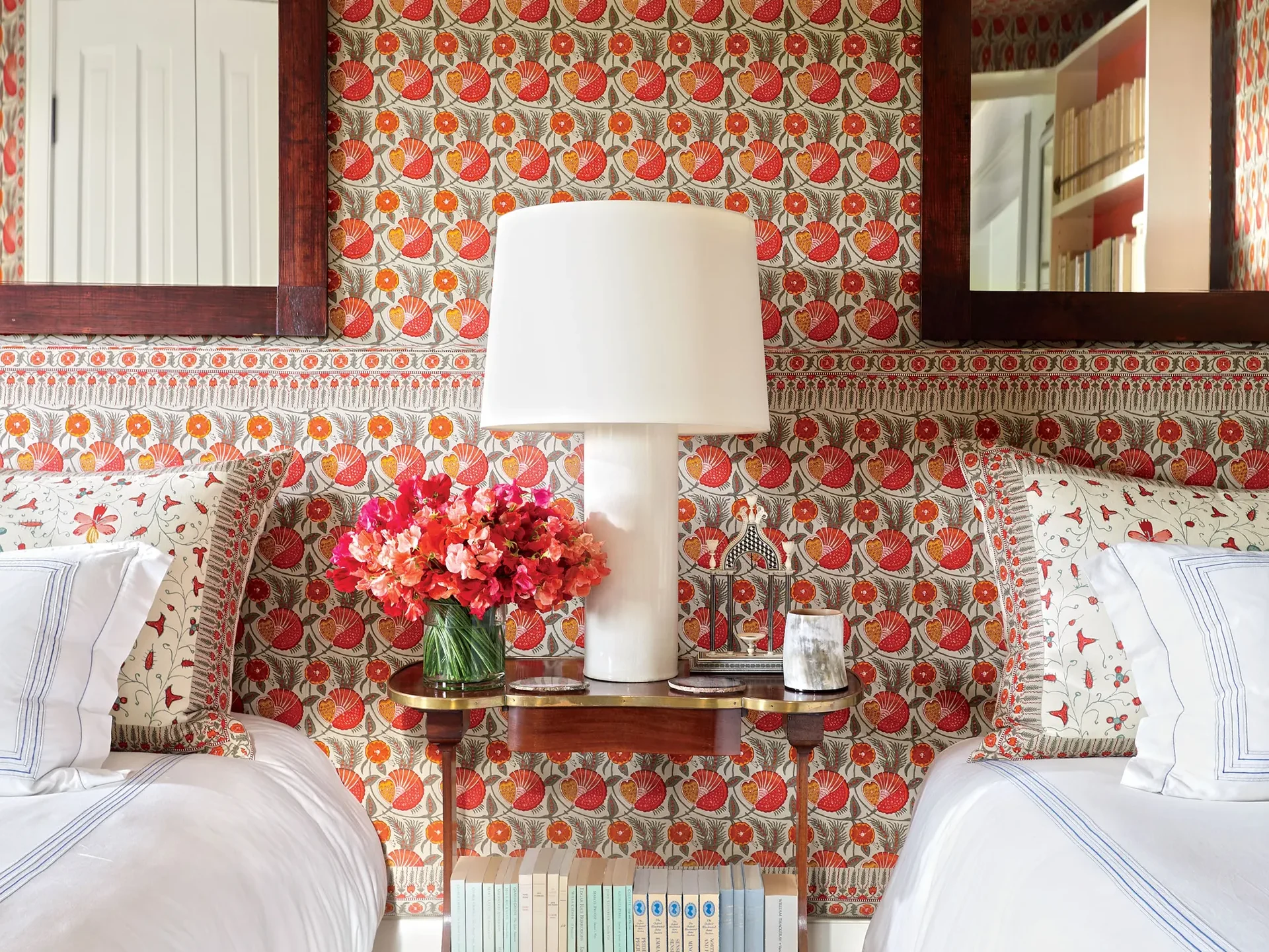 guest bedroom with flower wallpaper in red tones