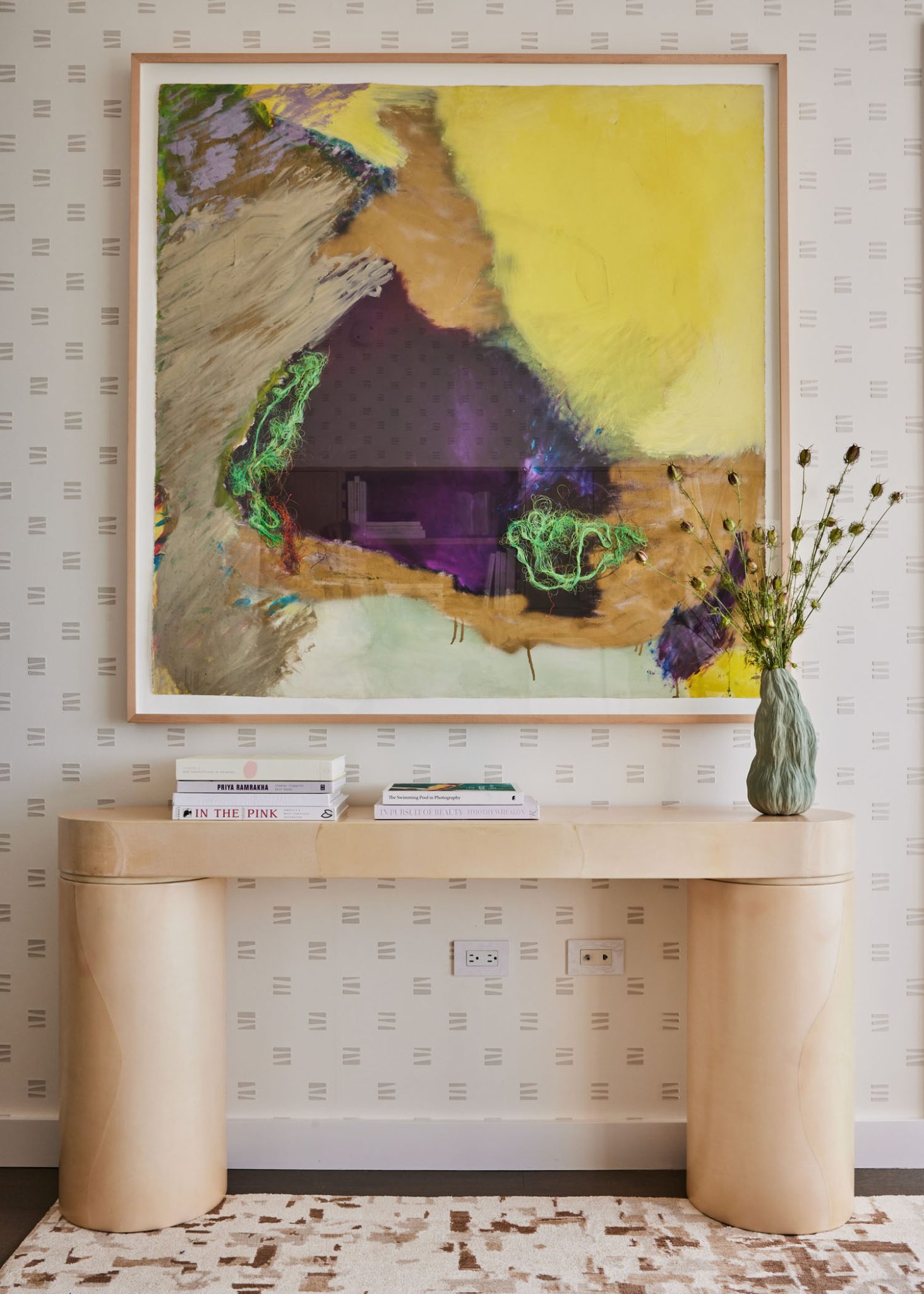 A colorful painting in a otherwise neutral toned hall