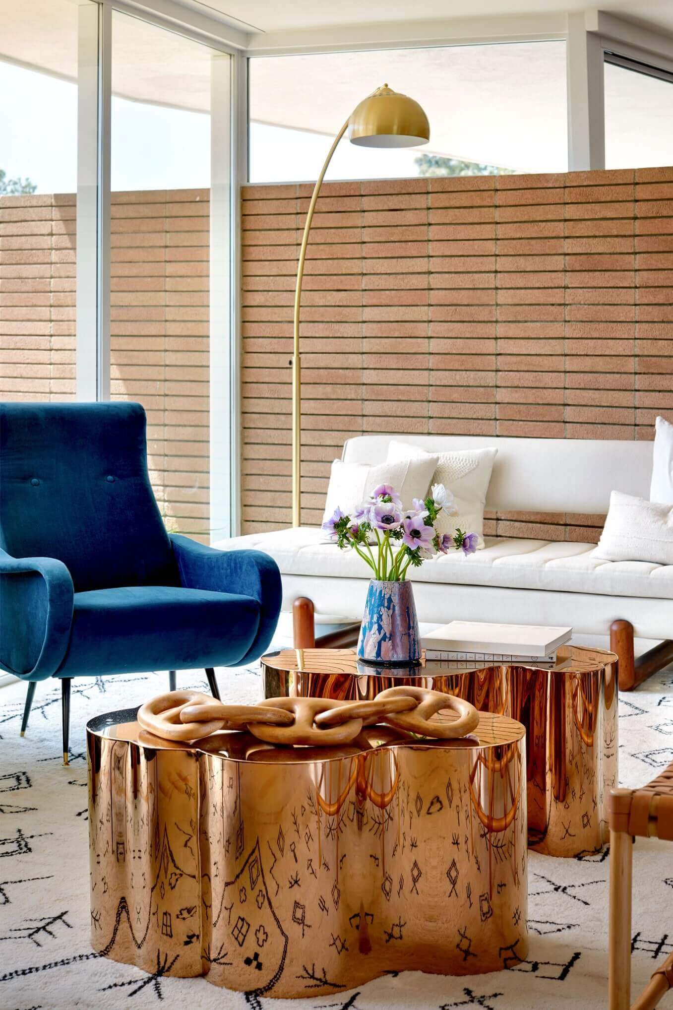 Living room featuring a blue armchair and a bold golden center table