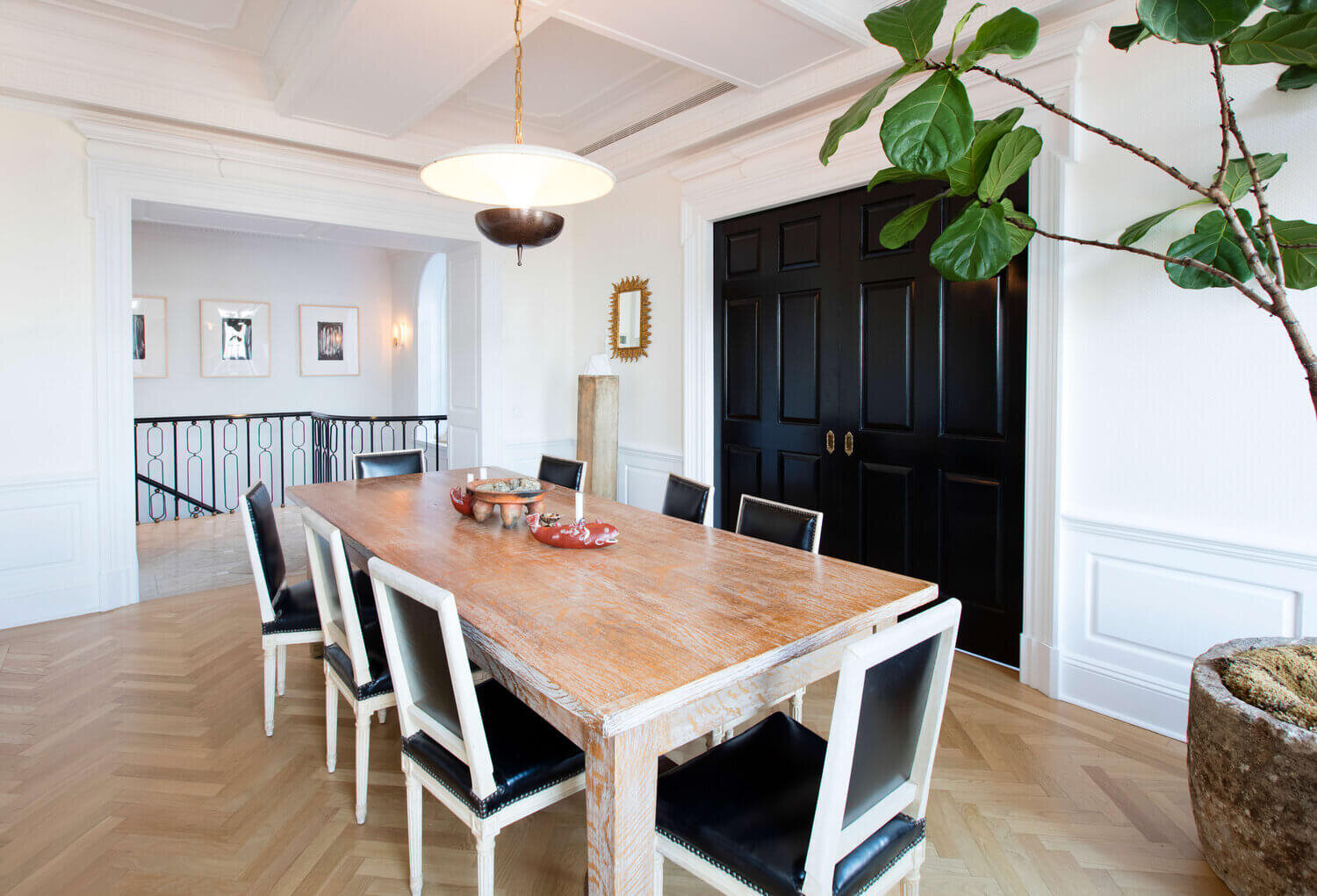 a modern dining room with black and white details designed by Nate Berkus & Jeremiah Brent