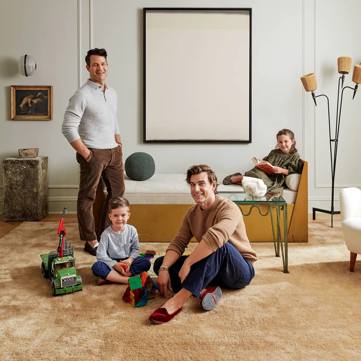 Jeremiah Brent and Nate Berkus with their two children at the living room of their mid-century modern home