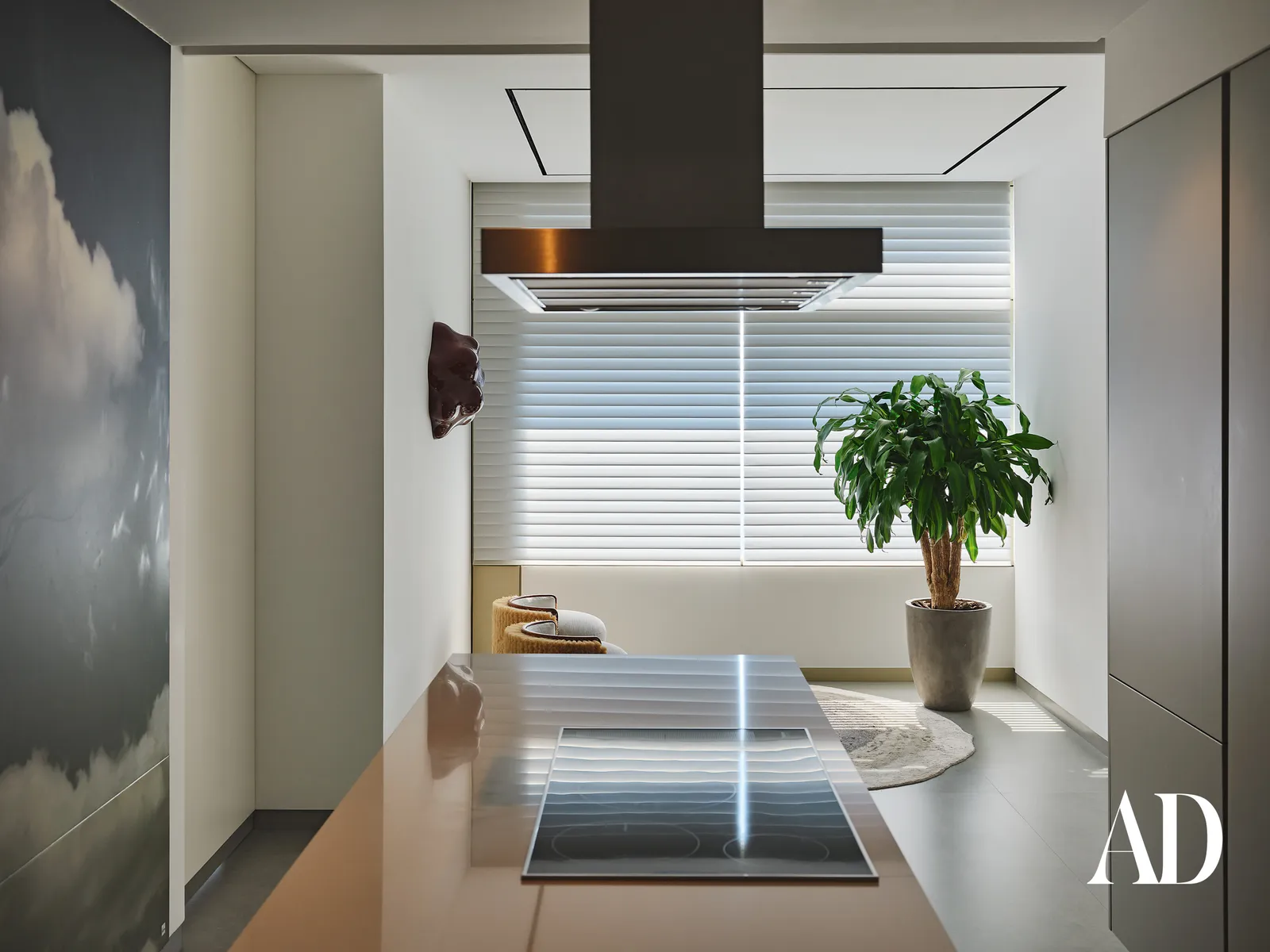The Art of Minimalist Luxury: Inside a Dubai Penthouse Inspired by Nature , kitchen with minimalist design, green plant and large window