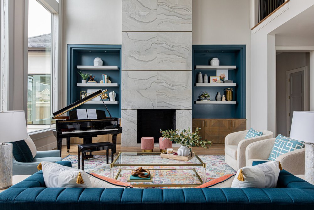 Fancy blue decorated living room with gray fire place