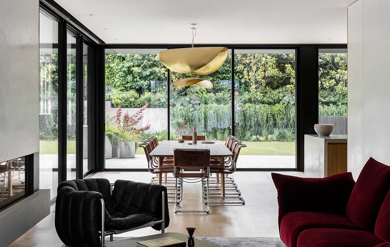 A modern dining room with a big golden suspension lamp