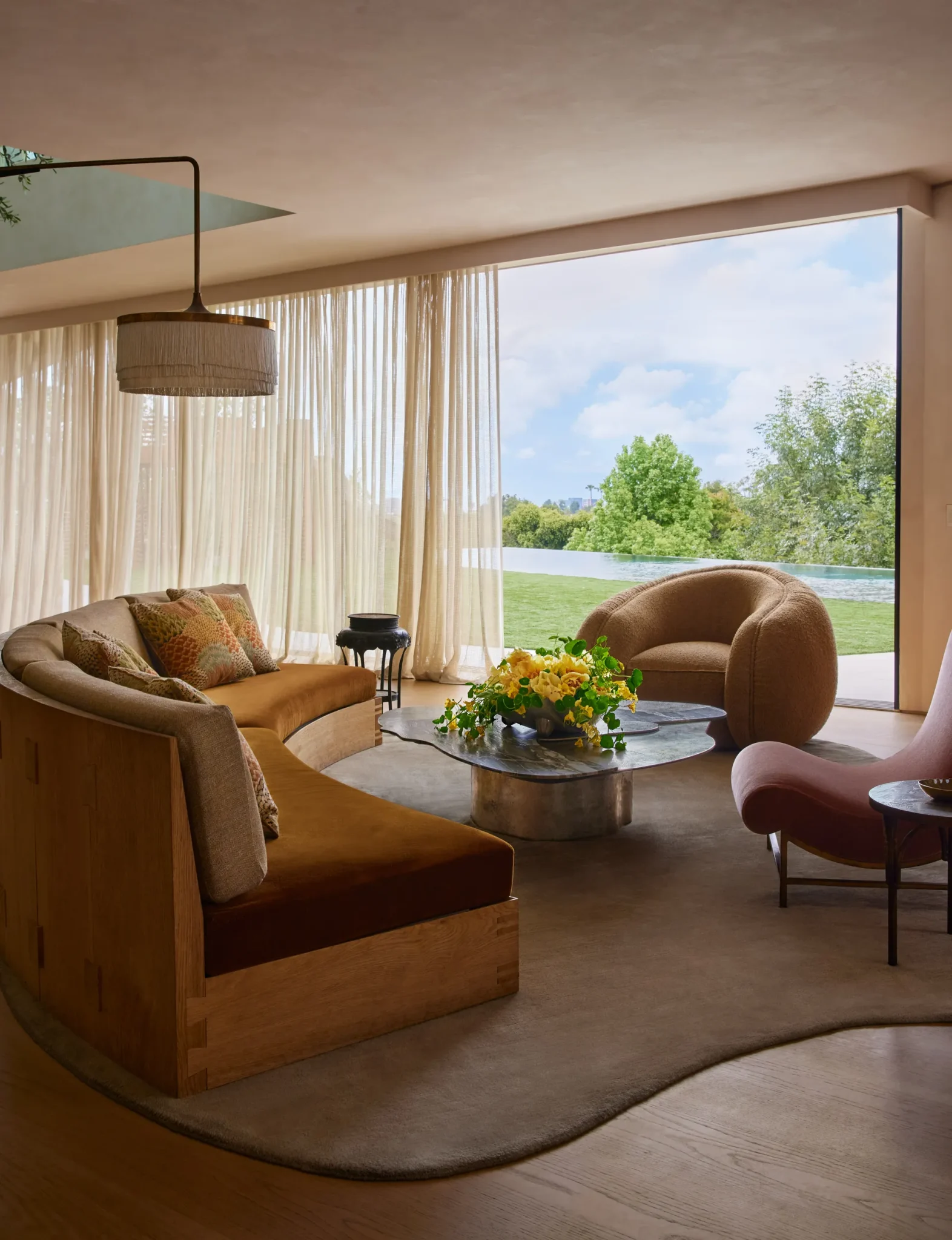 living room with a curved sofa, cocktail table and a floor lamp