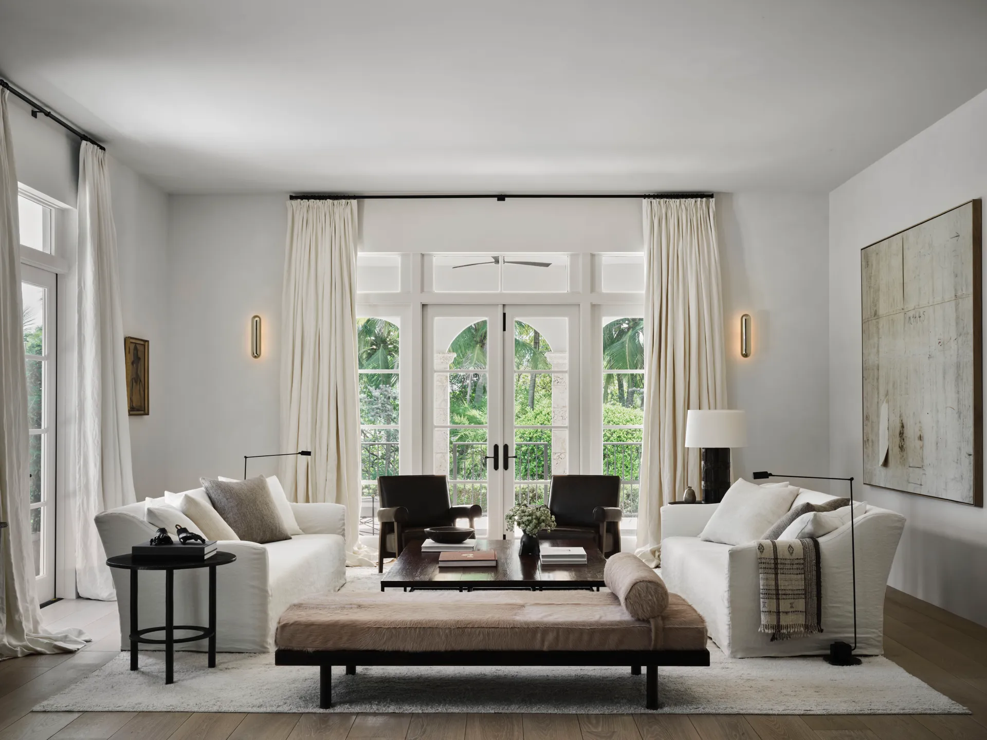 living room with cream colored walls and white linen sofas