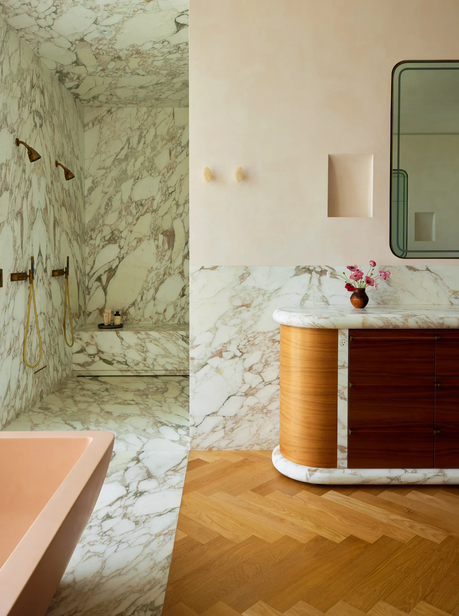primary bathroom features a custom marble-and-walnut vanity, broad expanses of calacatta monet marble