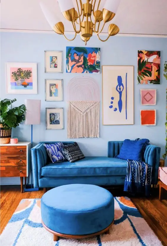 Blue maximalist styled living room, with the theme blue and wood pieces and floor