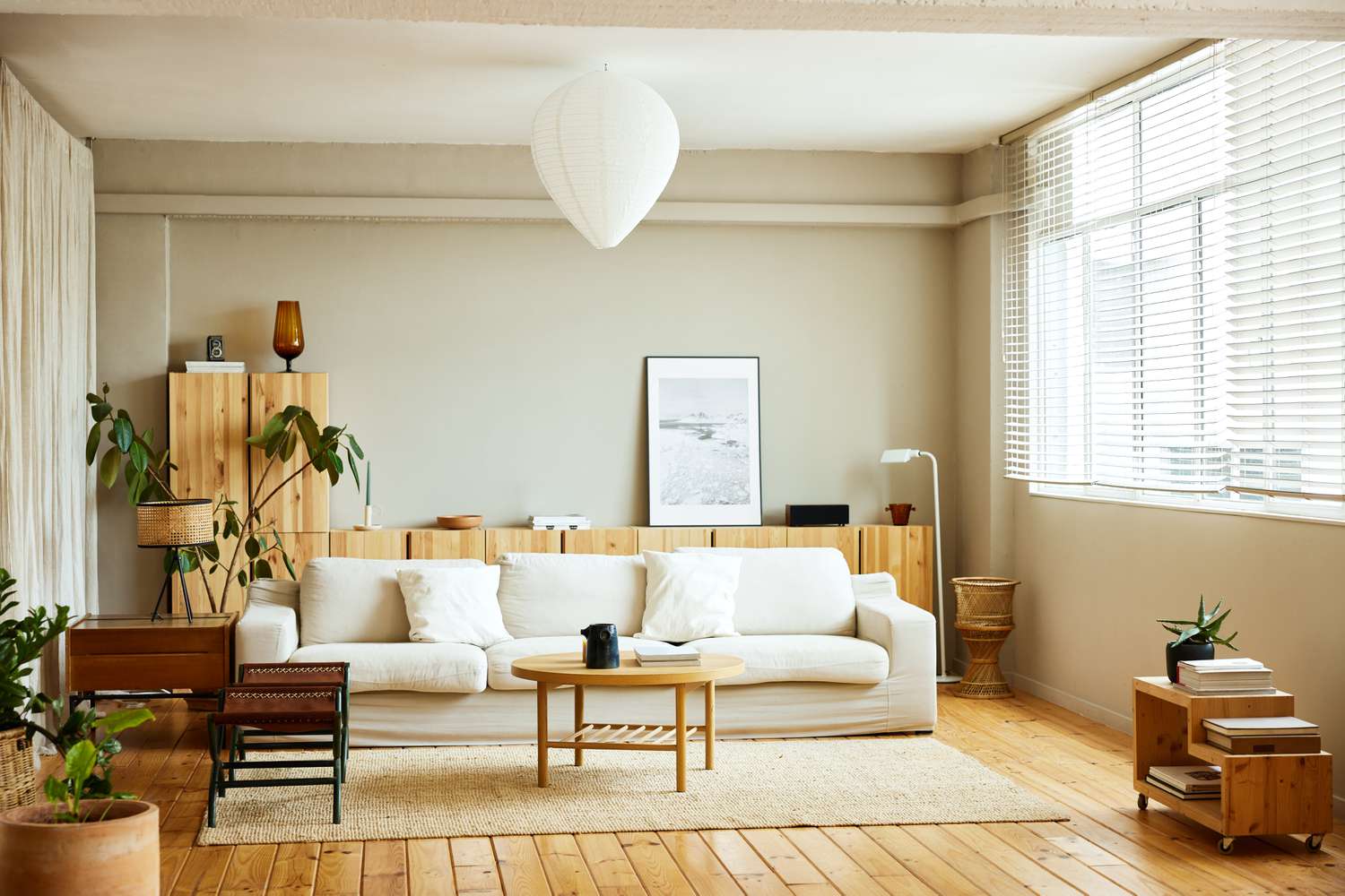 This bright, airy dining room is illuminated by natural light through skylights, showcasing a minimalist approach to lighting trends.