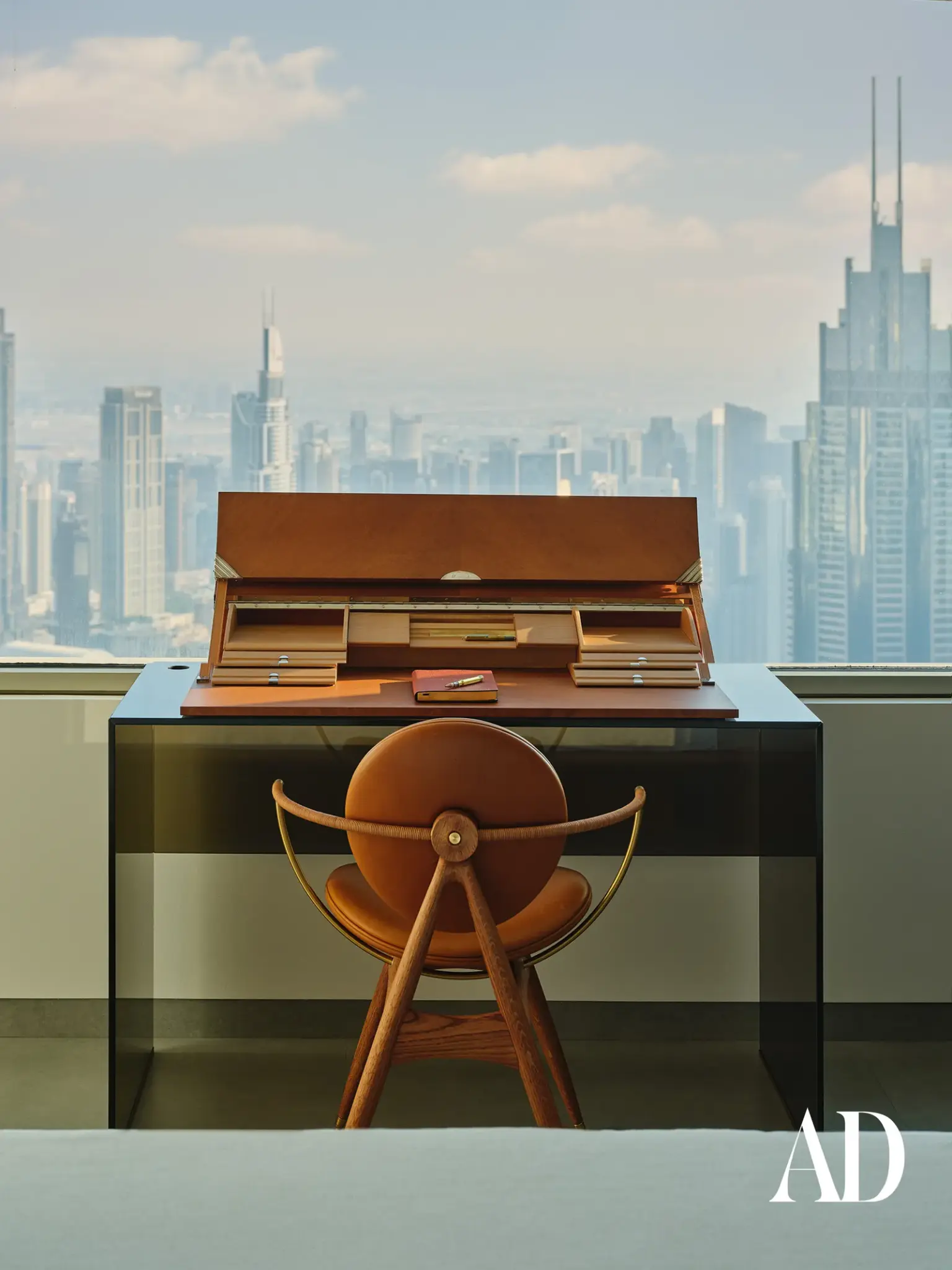 The Art of Minimalist Luxury: Inside a Dubai Penthouse Inspired by Nature , office space with glass table and designer´s chair